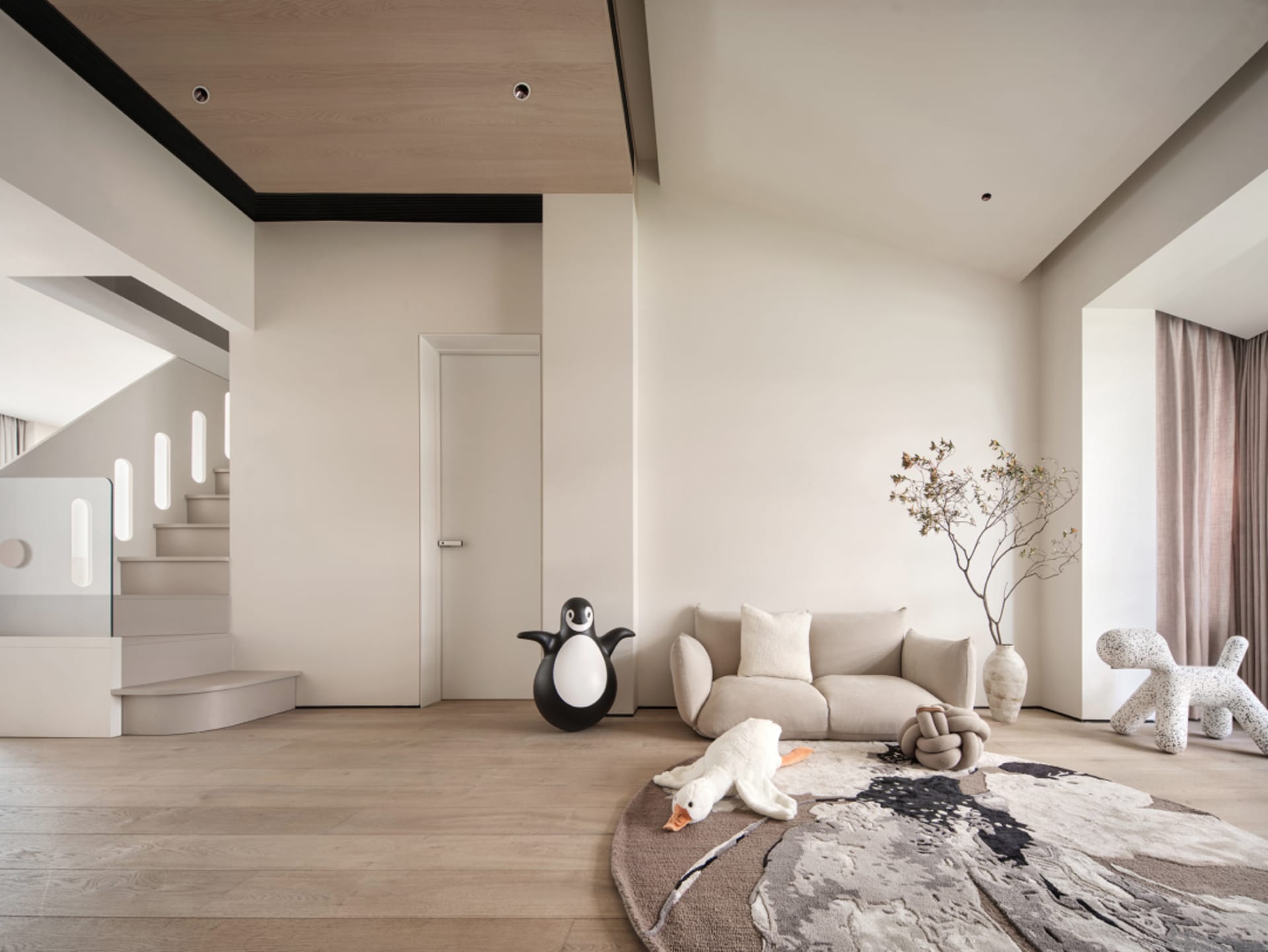 Modern minimalist living room featuring wooden flooring, marble sofa, and abstract rug.