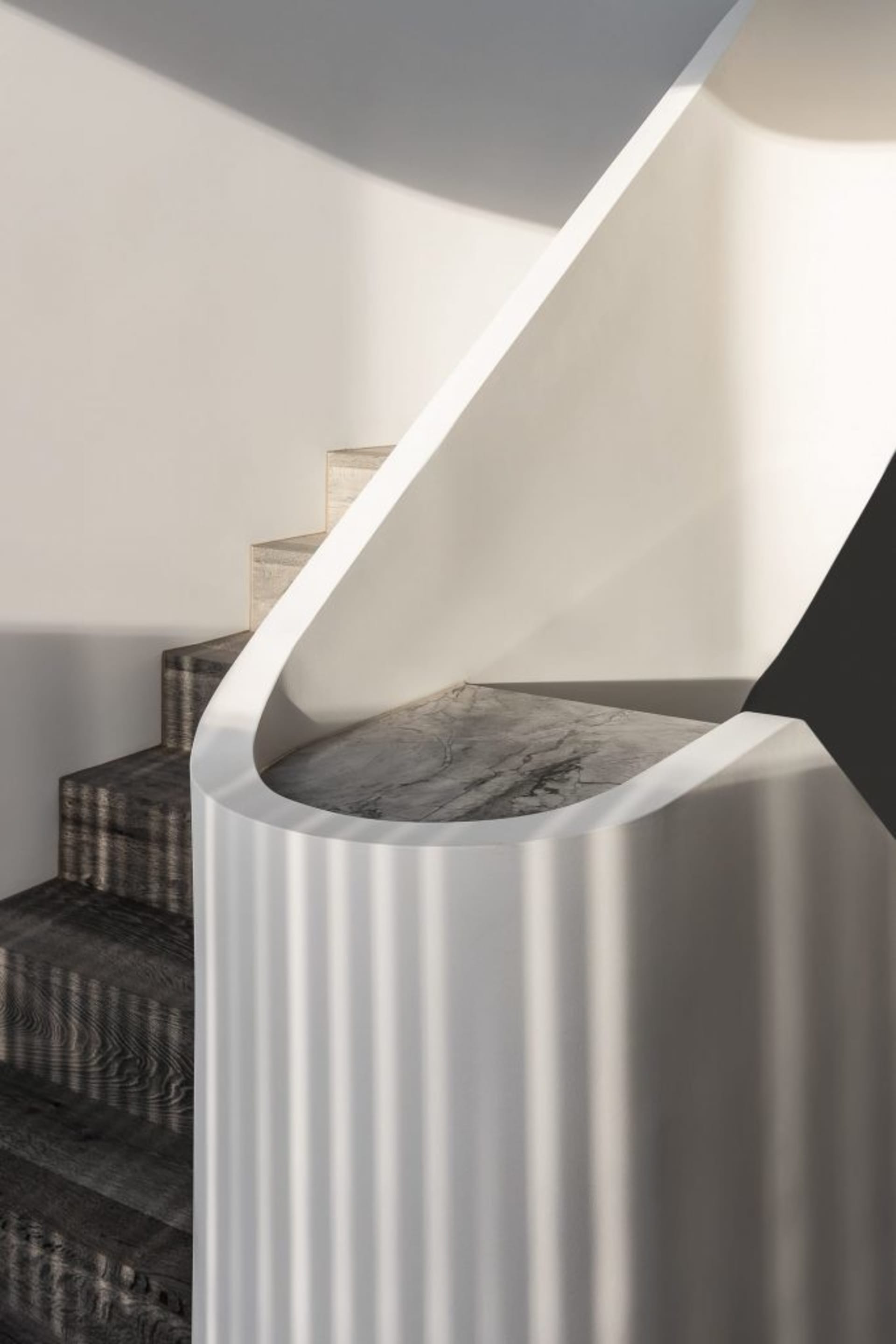 Modern staircase design featuring concrete steps and railings.