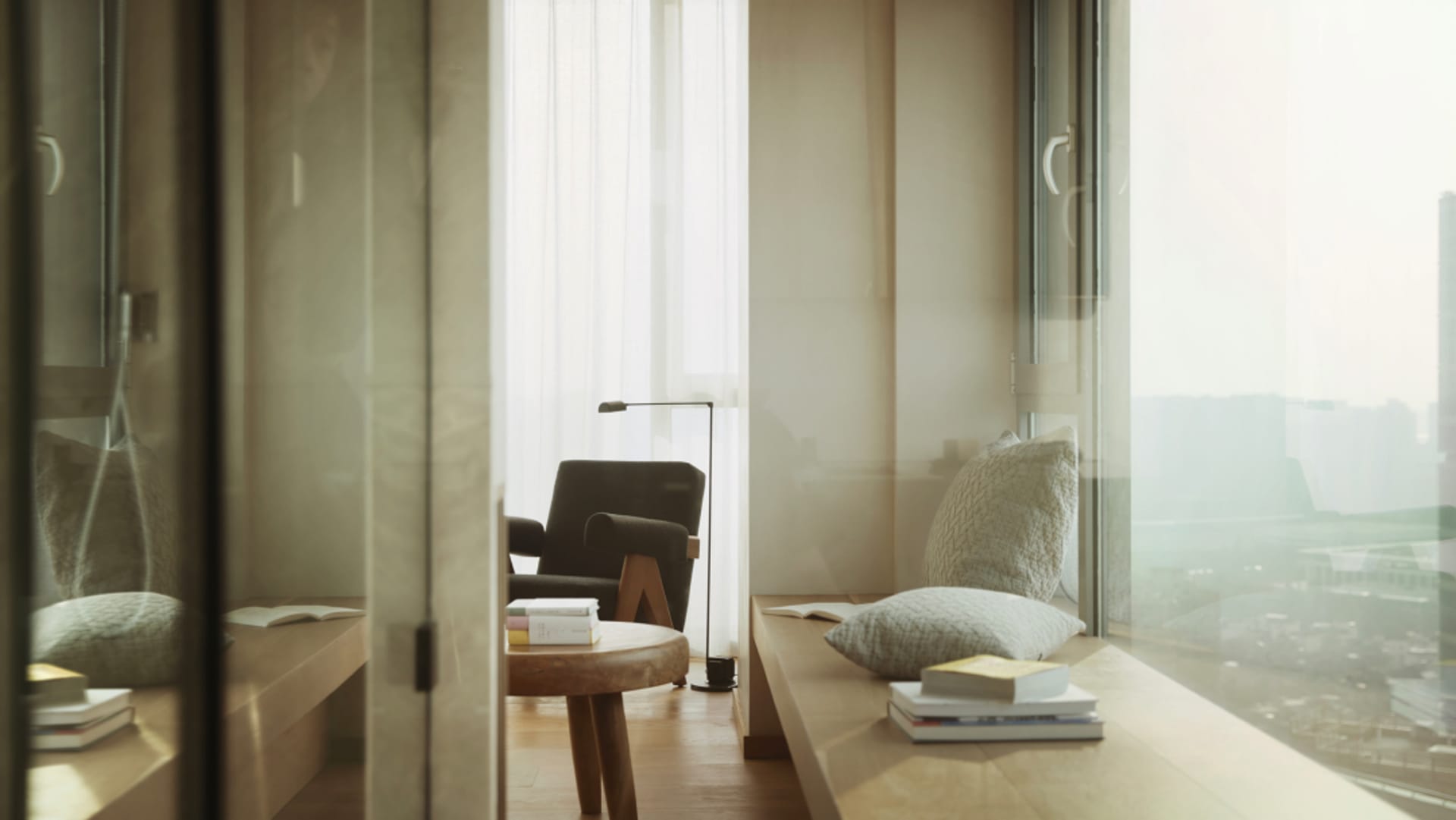 A modern living room with a neutral color palette, featuring a window seat, books, and a minimalist armchair with floor lamp.