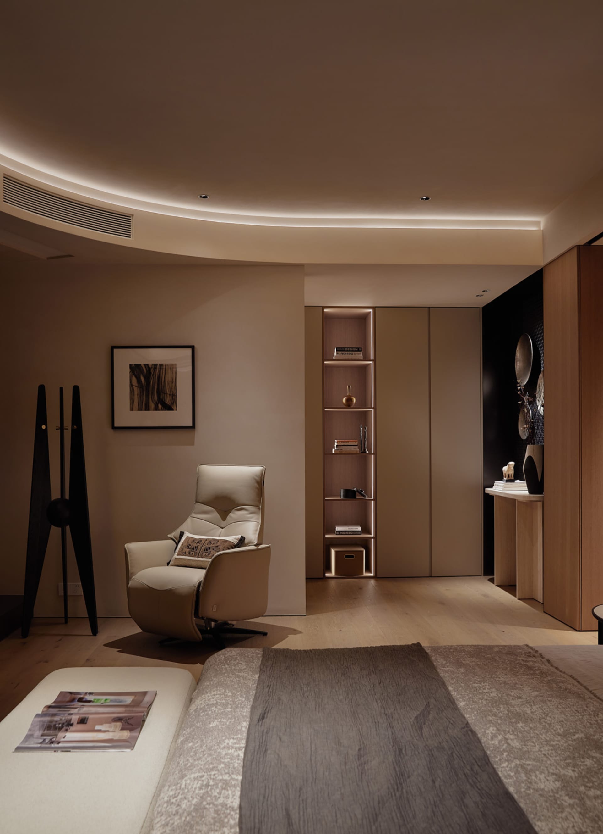 A minimalist bedroom featuring a wooden floor and furniture.