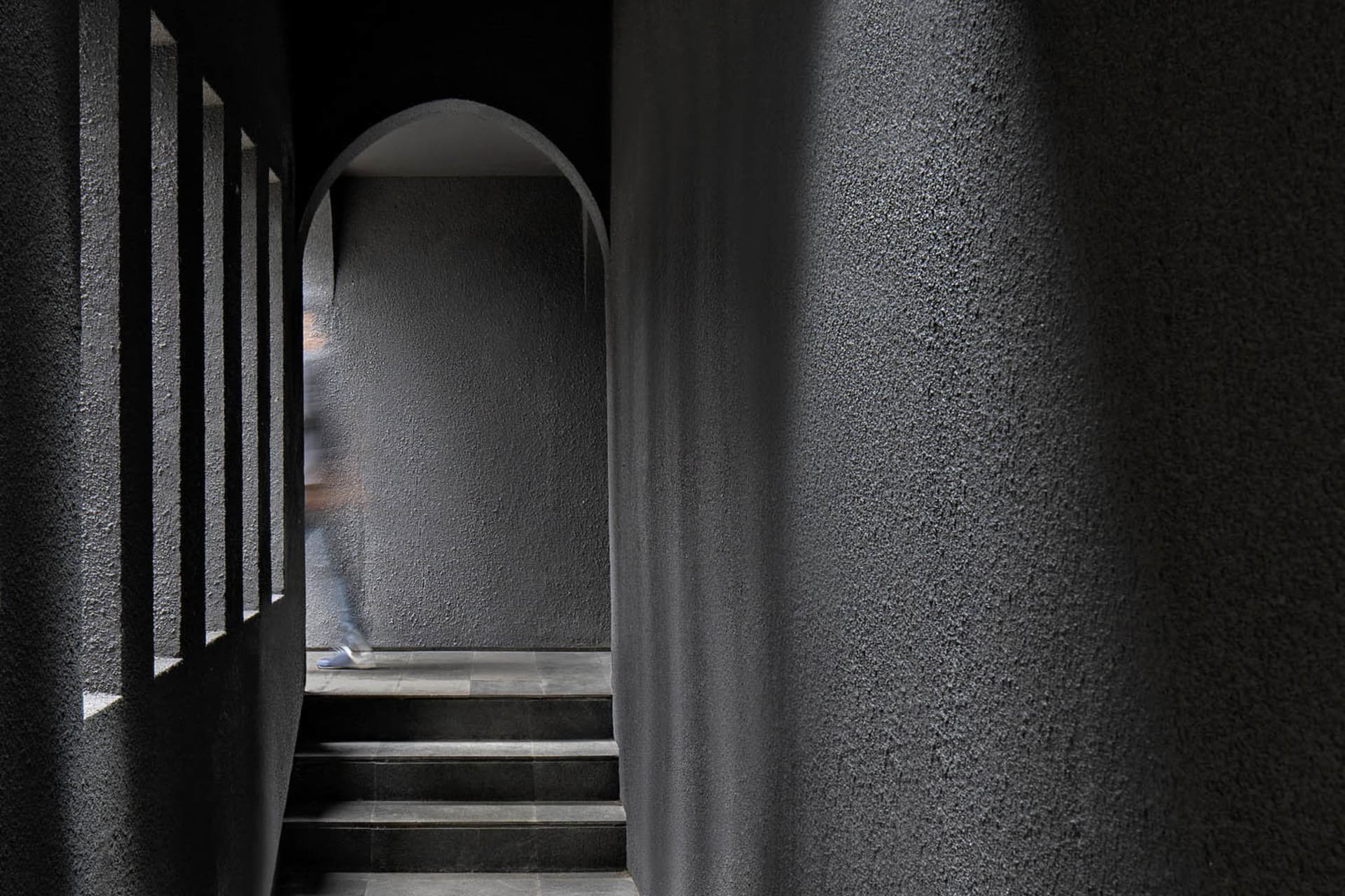A modern staircase constructed from concrete, with a minimalist design and a single step visible.