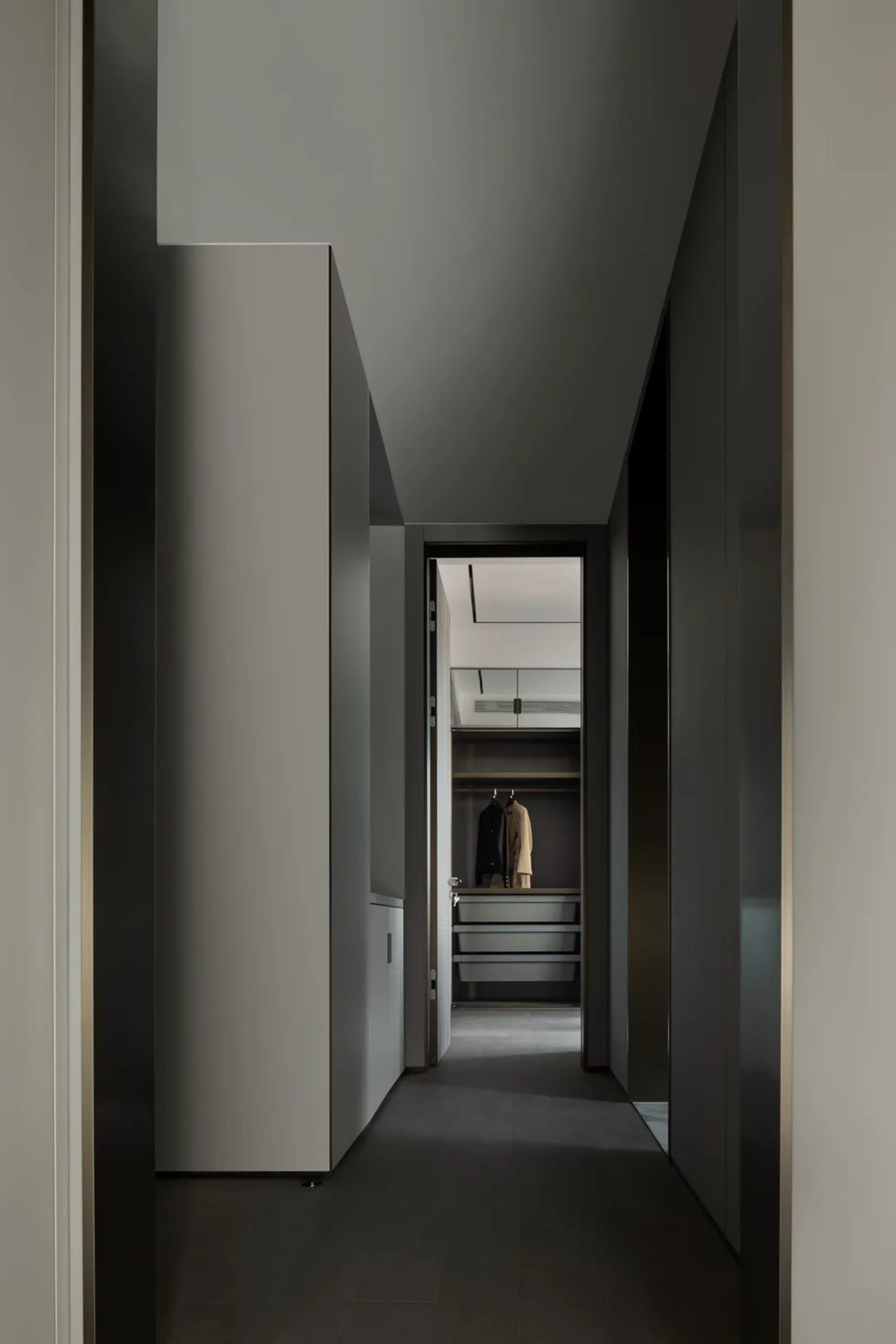 A minimalist closet interior with metallic finishes, featuring a sleek, contemporary design.