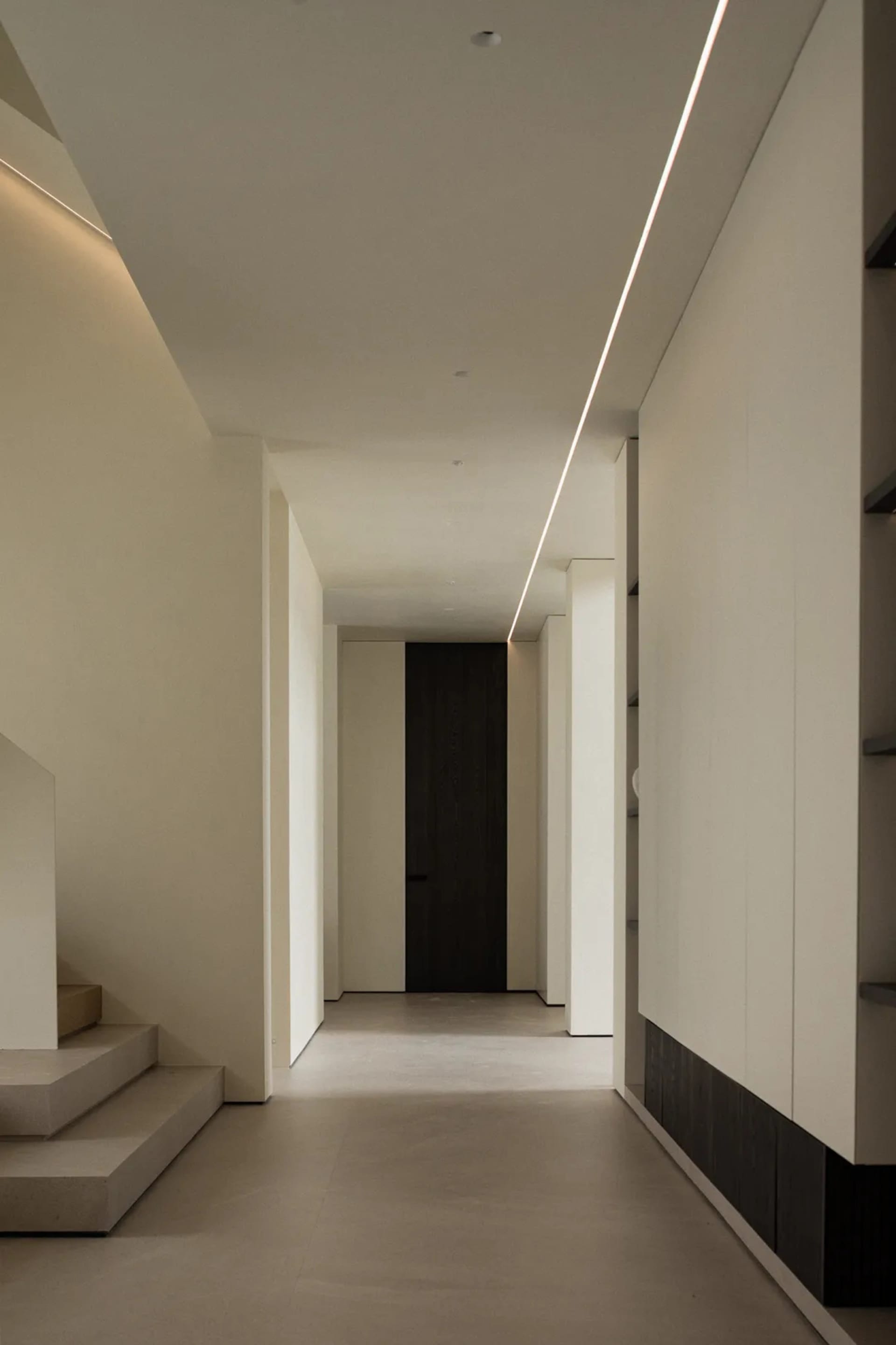 A modern interior space featuring concrete walls and floors.