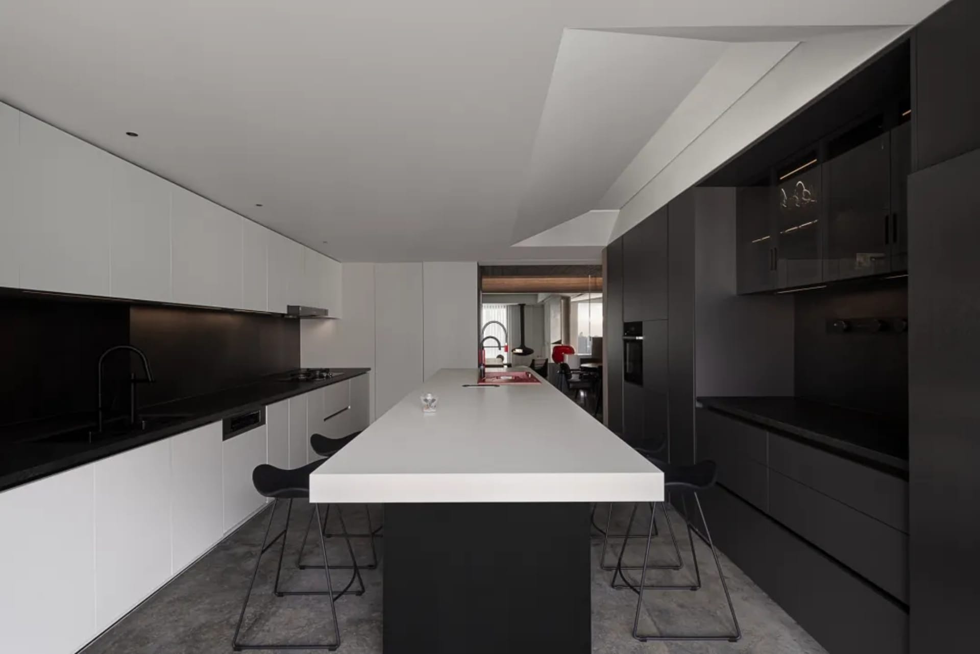 Contemporary kitchen with concrete countertops and minimalist design.