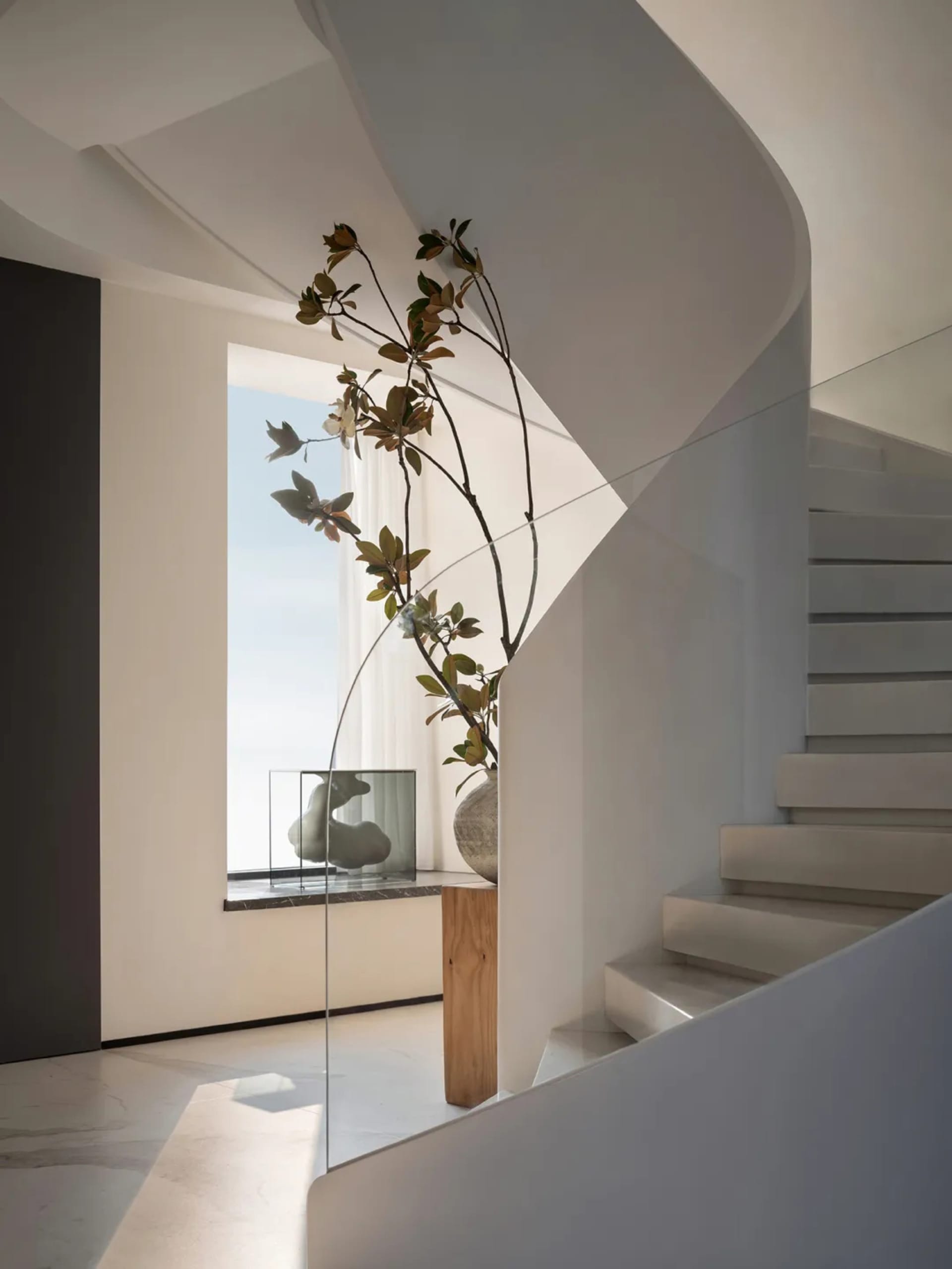 Modern staircase featuring glass railings and minimalist design.