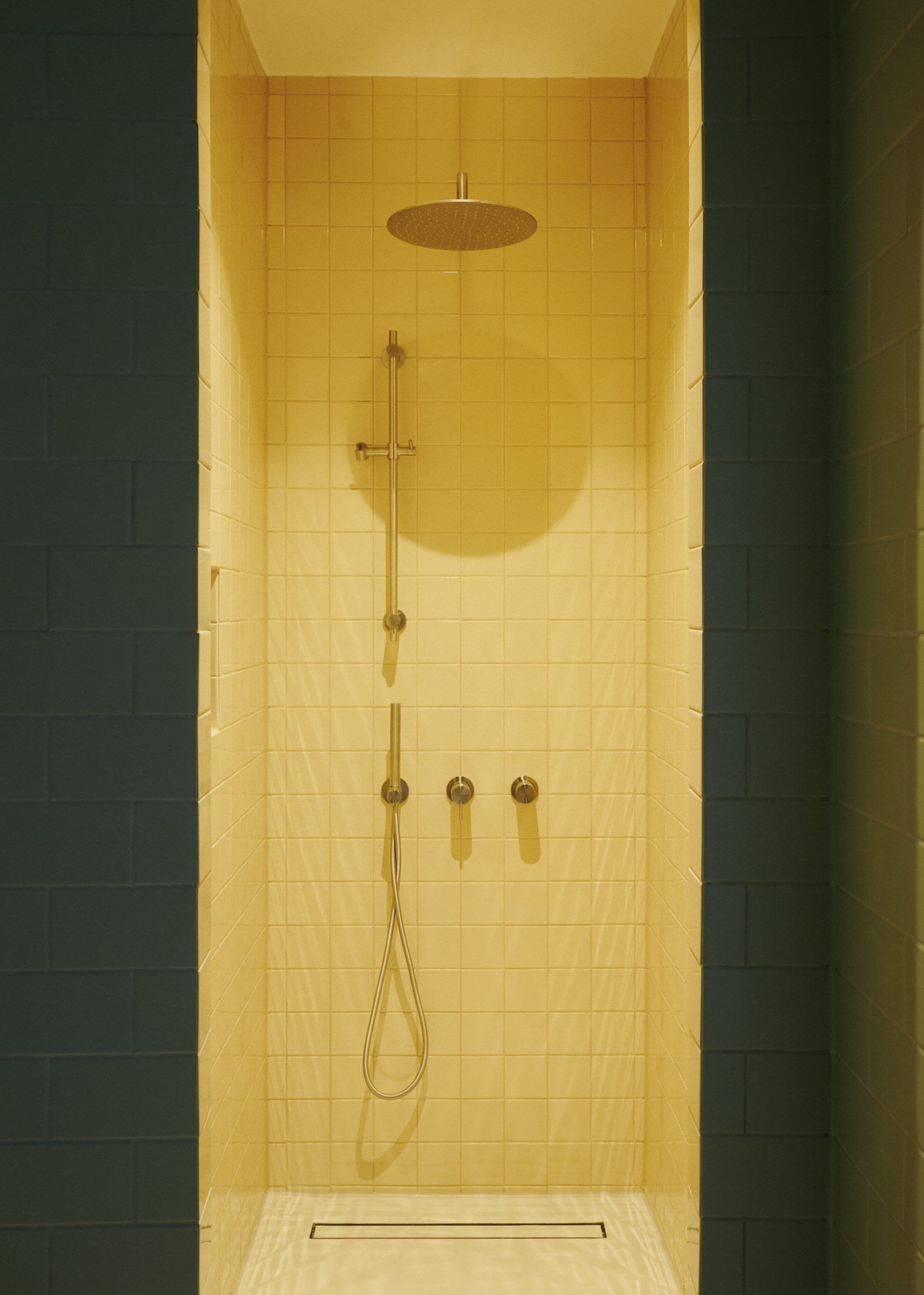 Yellow-tiled minimalist bathroom with modern fixtures.