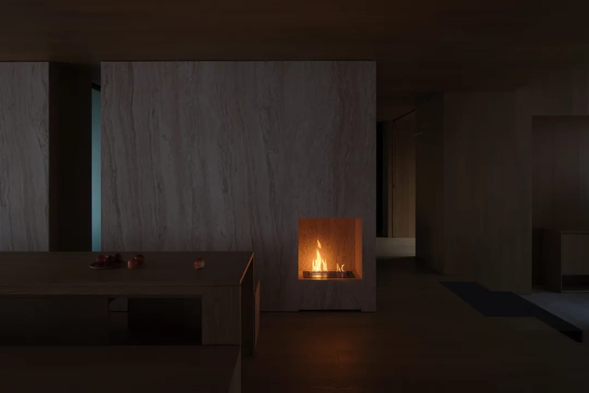 A minimalist living room with marble walls and a fireplace.