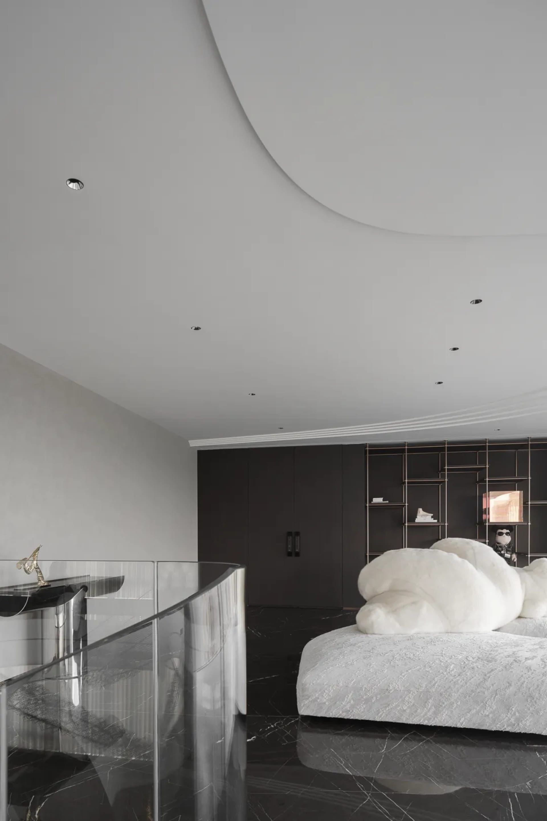 A minimalist bedroom featuring marble flooring and metallic accents