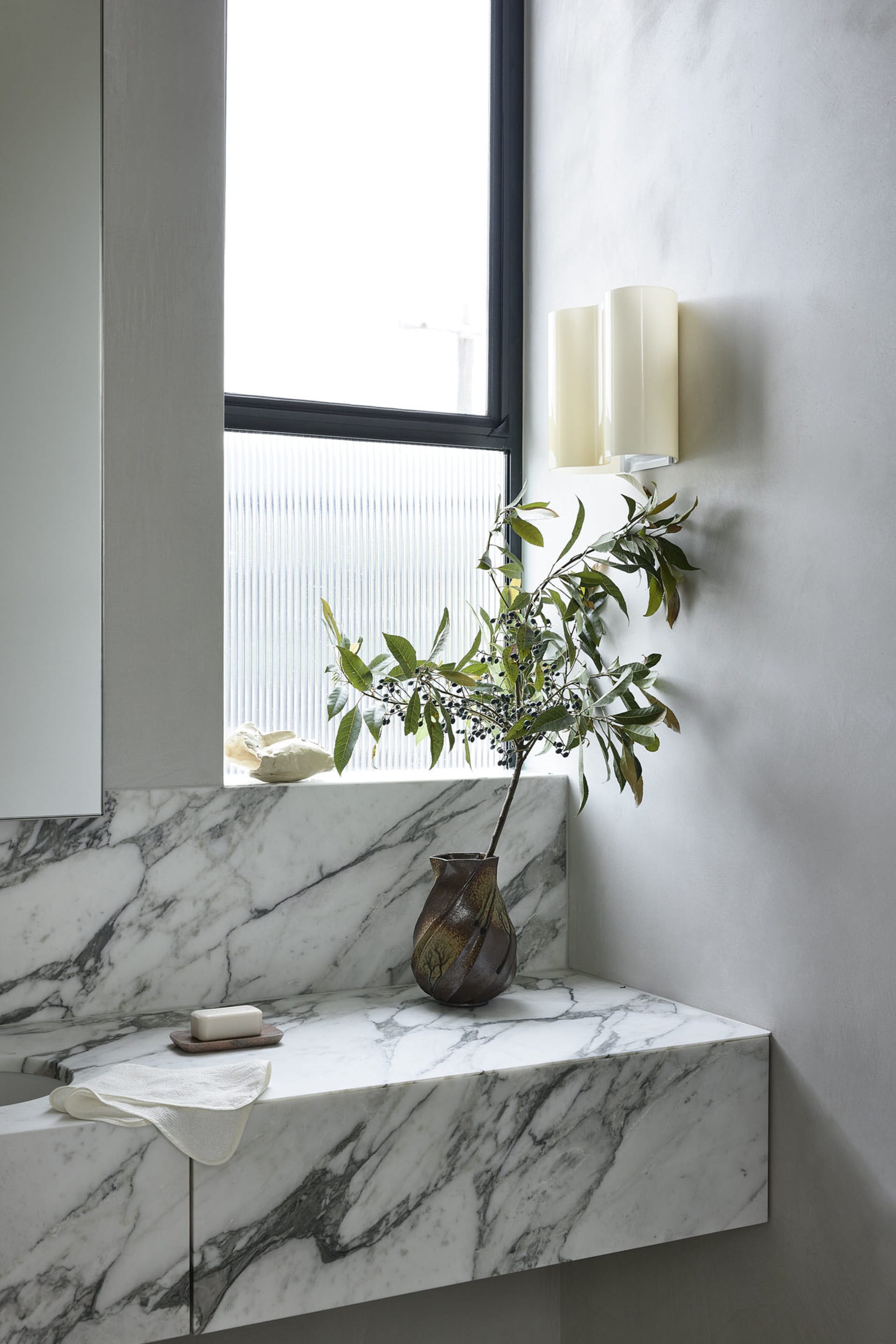 a minimalist bathroom with marble finishes, showcasing sleek and elegant designs.