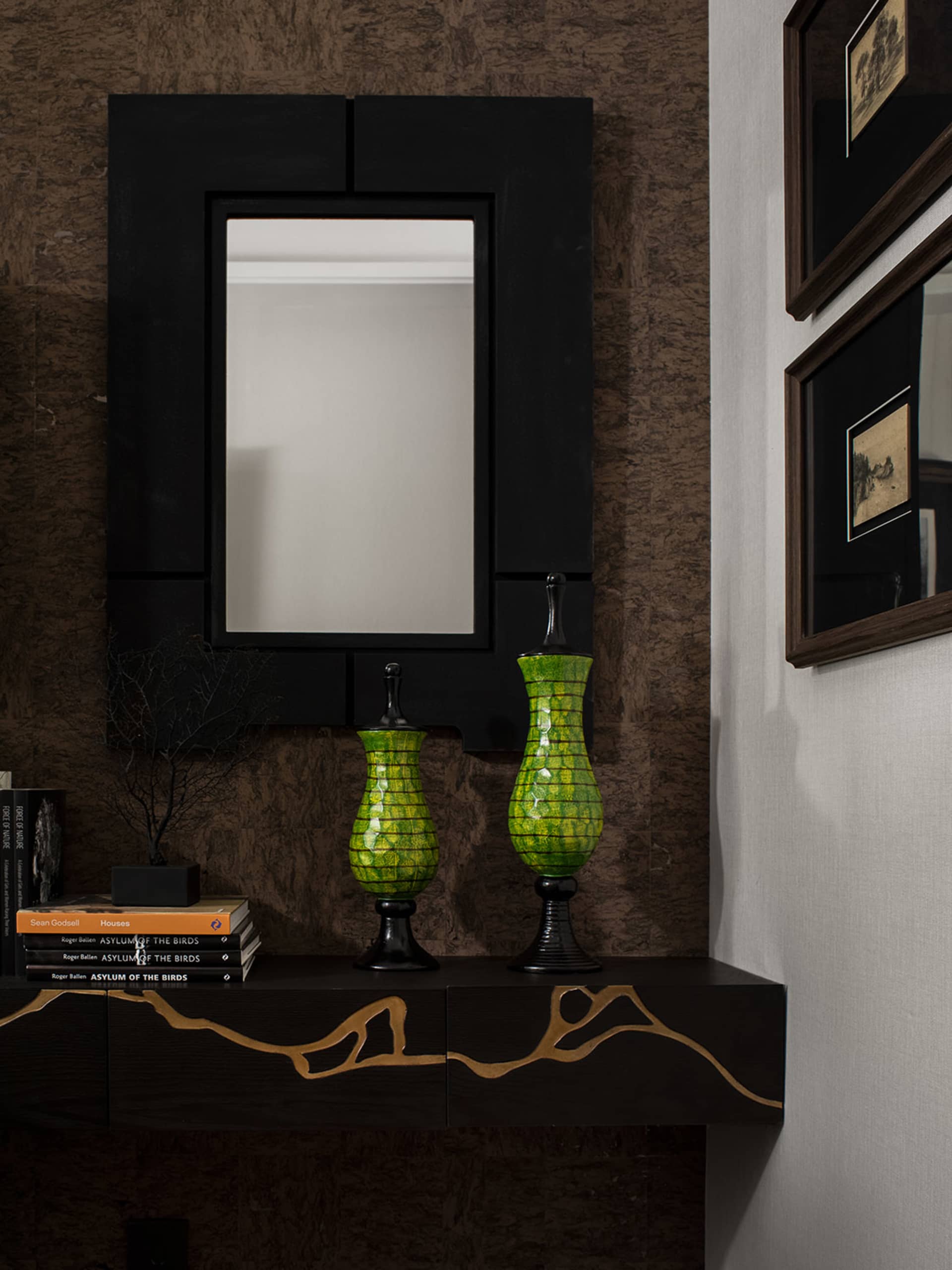 A modern console table with black and gold decorative elements