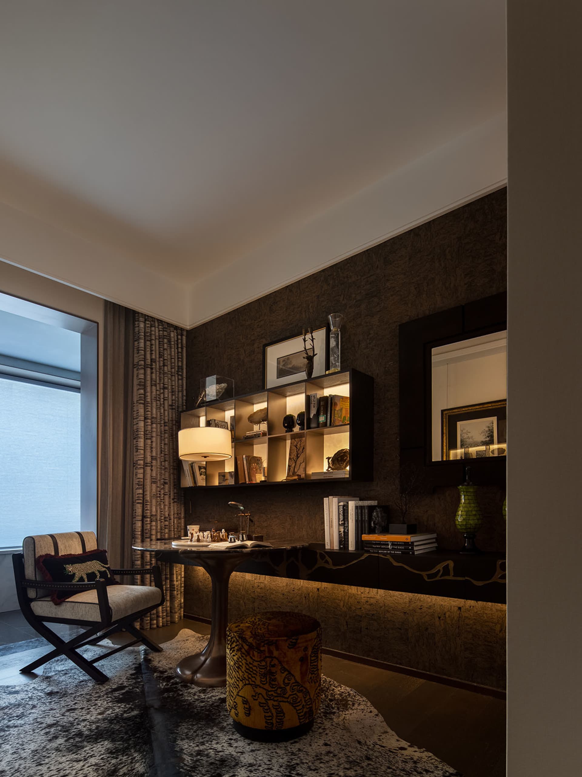 A modern living room featuring wooden furniture and brown tones.