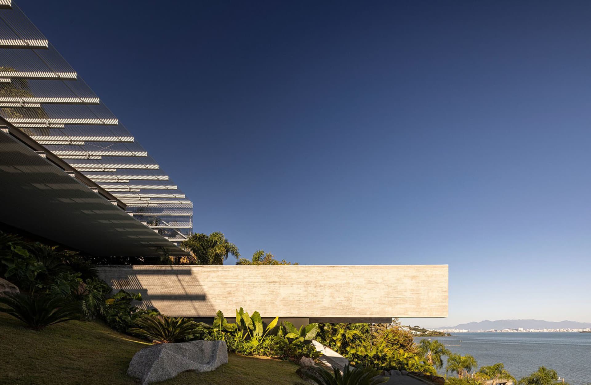 A modern residential building with a concrete exterior and glass window.