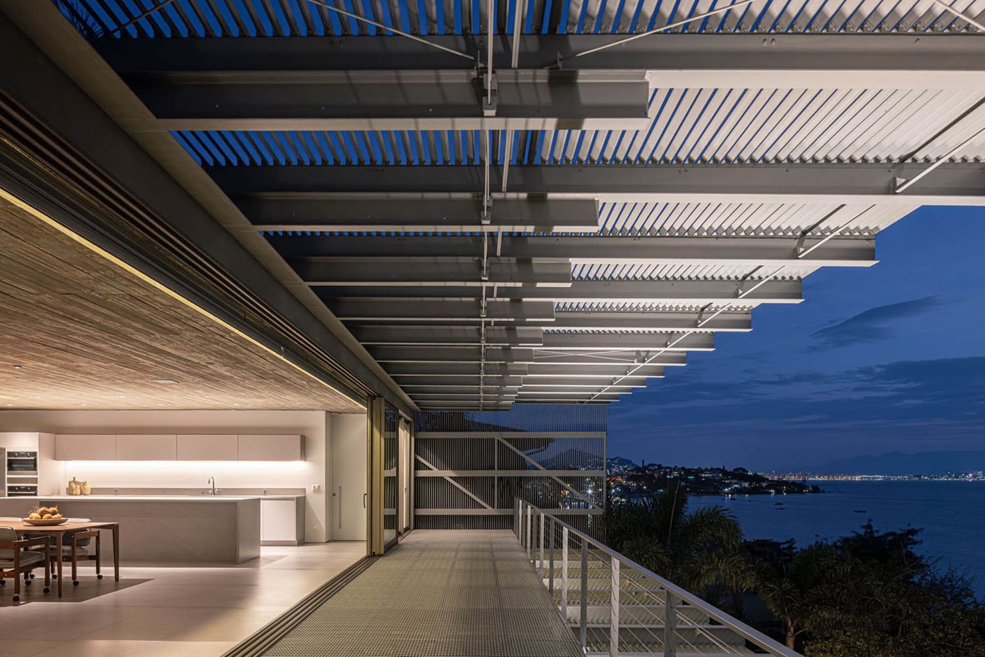 A modern residential architecture featuring metal, glass, and wood materials.
