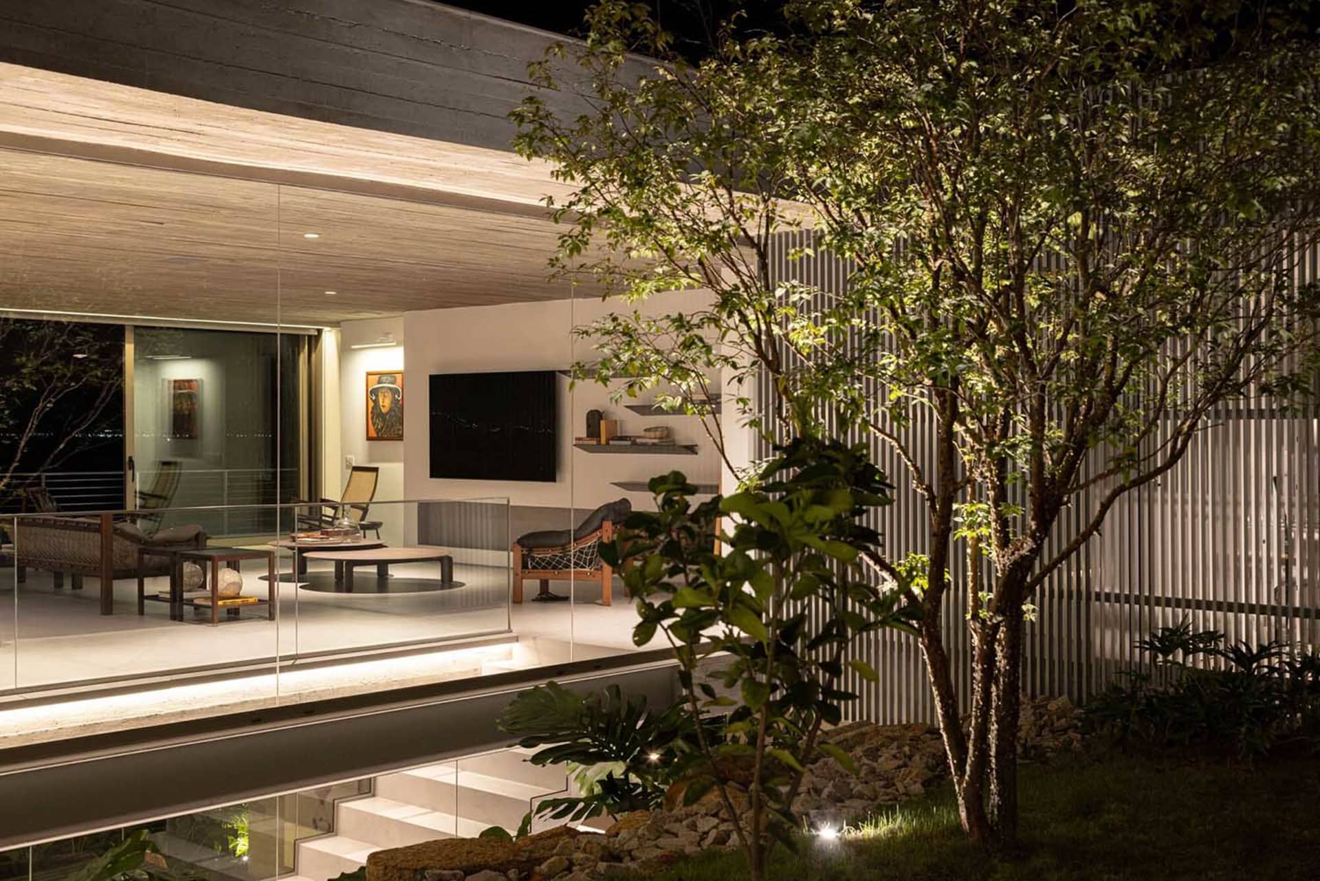 A modern living room featuring concrete walls and floors.