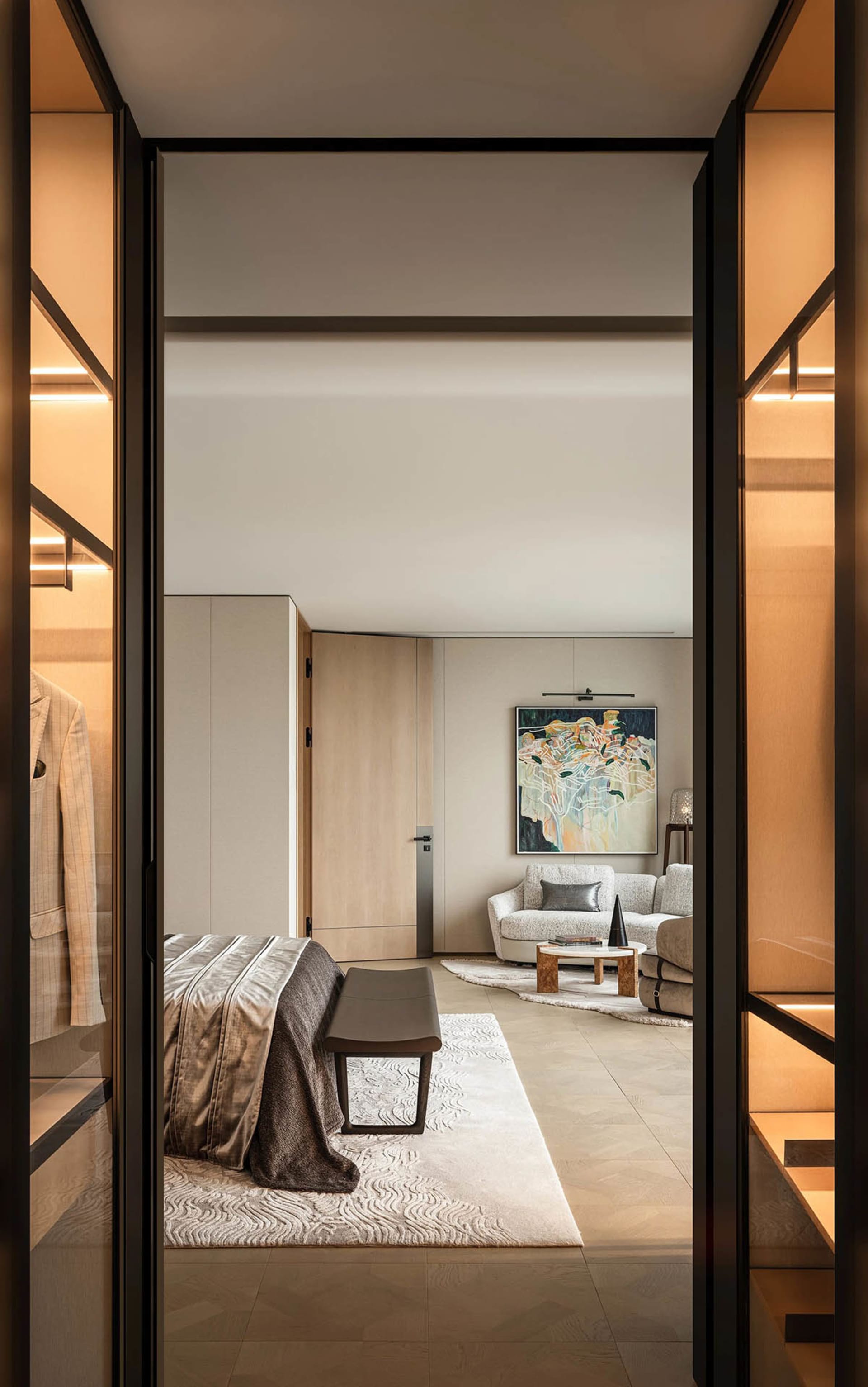 Interior design photo of a modern bedroom featuring wooden furniture and fabric-covered seating.