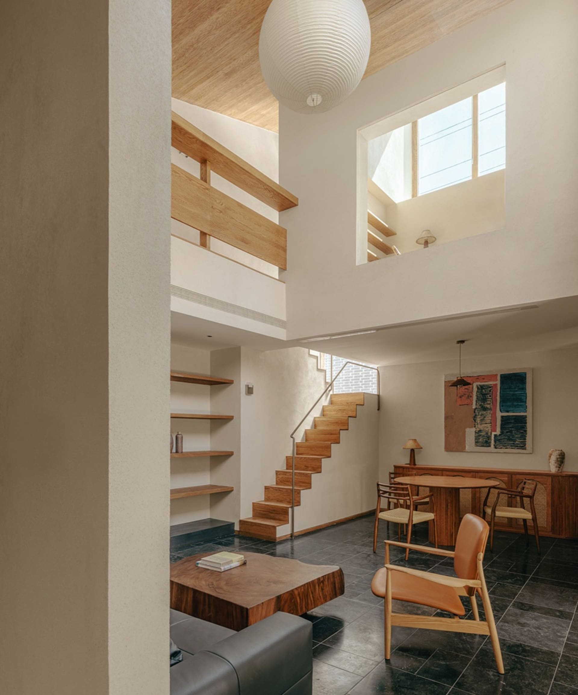 A modern residential living room featuring wooden accents and open-plan design.