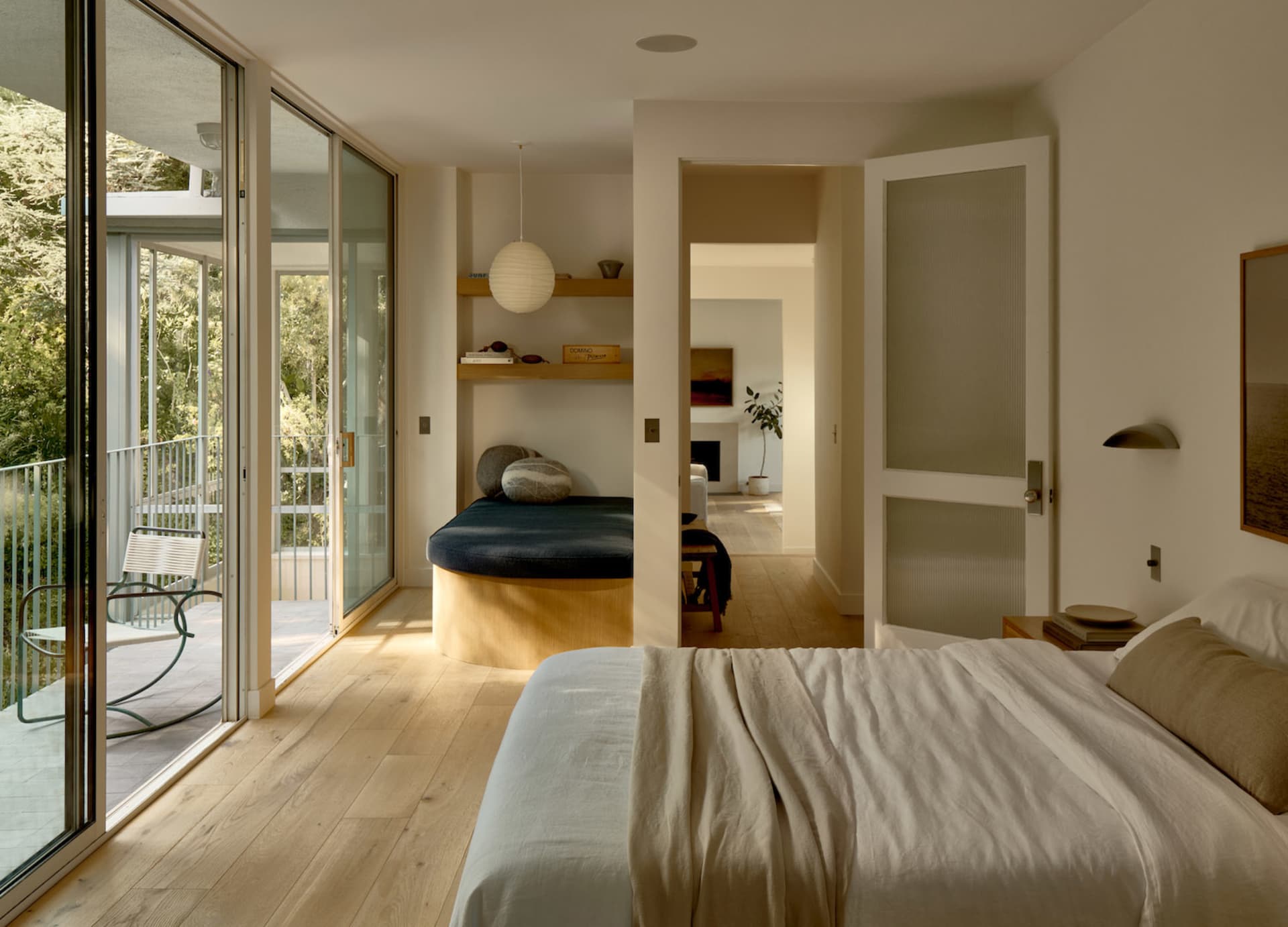 A serene minimalist bedroom with neutral tones and natural light.