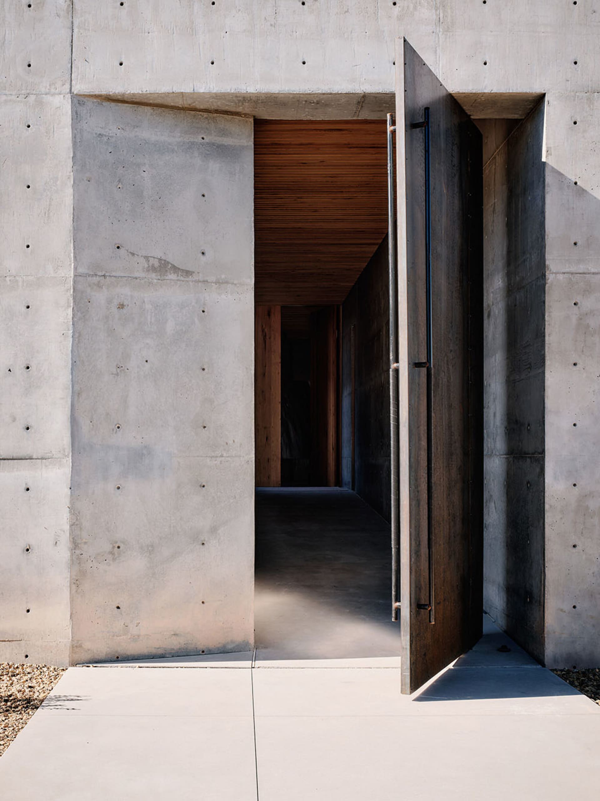Concrete entrance with wooden accents