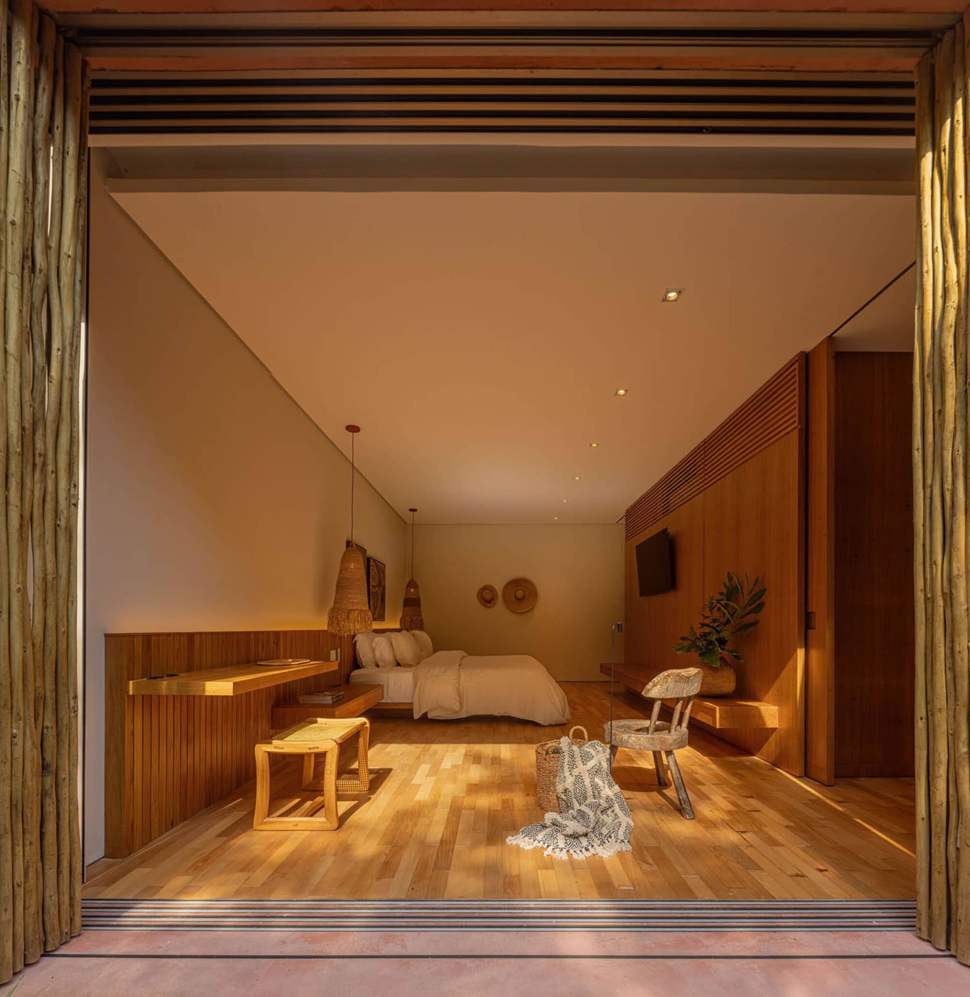 A modern minimalist bedroom featuring wooden elements and a cozy ambiance.