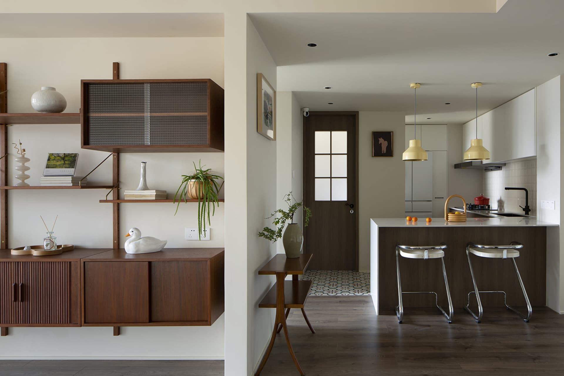 A modern kitchen with minimalist design and wooden features.