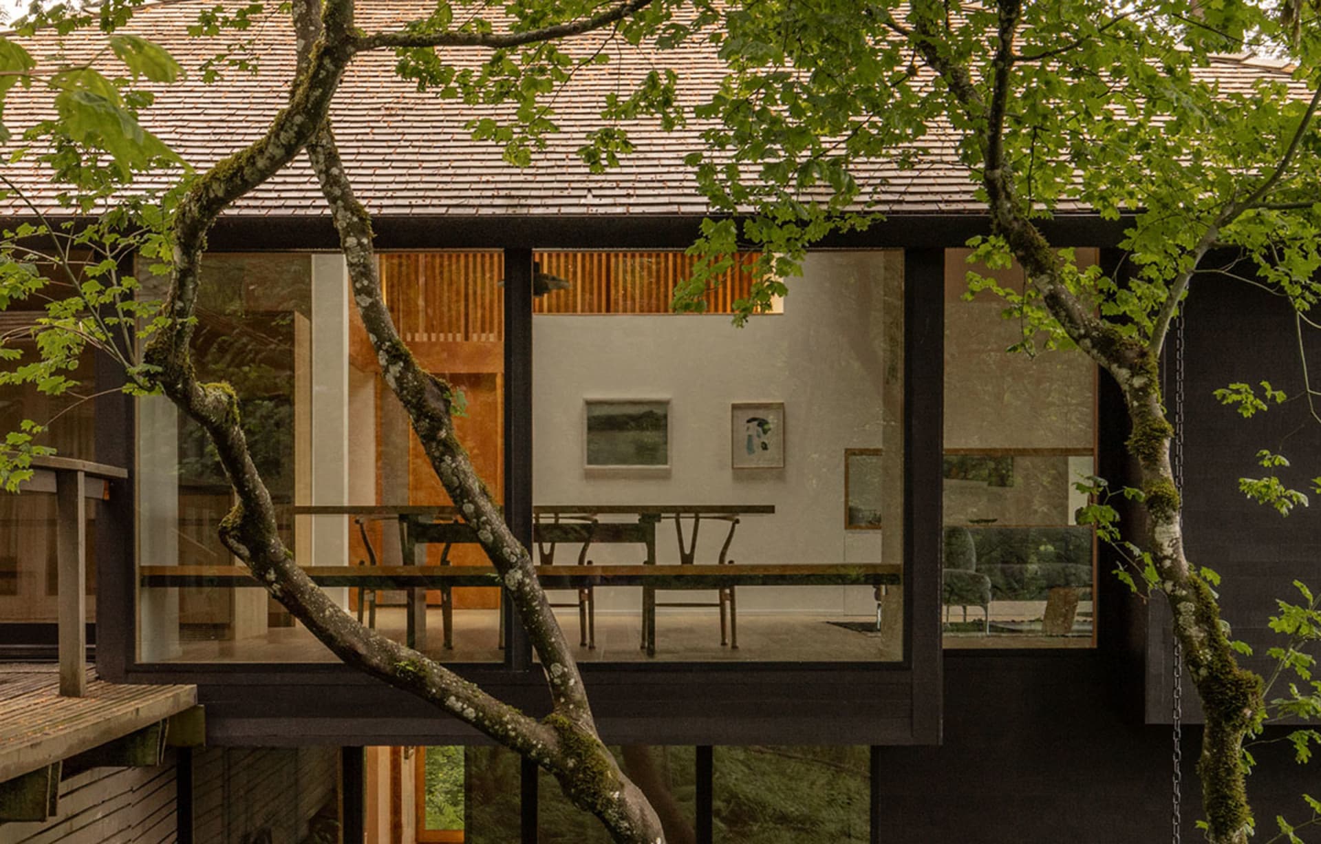 Interior view of a modern living and dining room with wood finishes.
