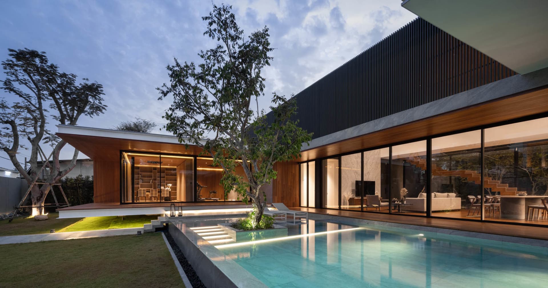 Modern residential exterior featuring wooden frame and steel panel materials.
