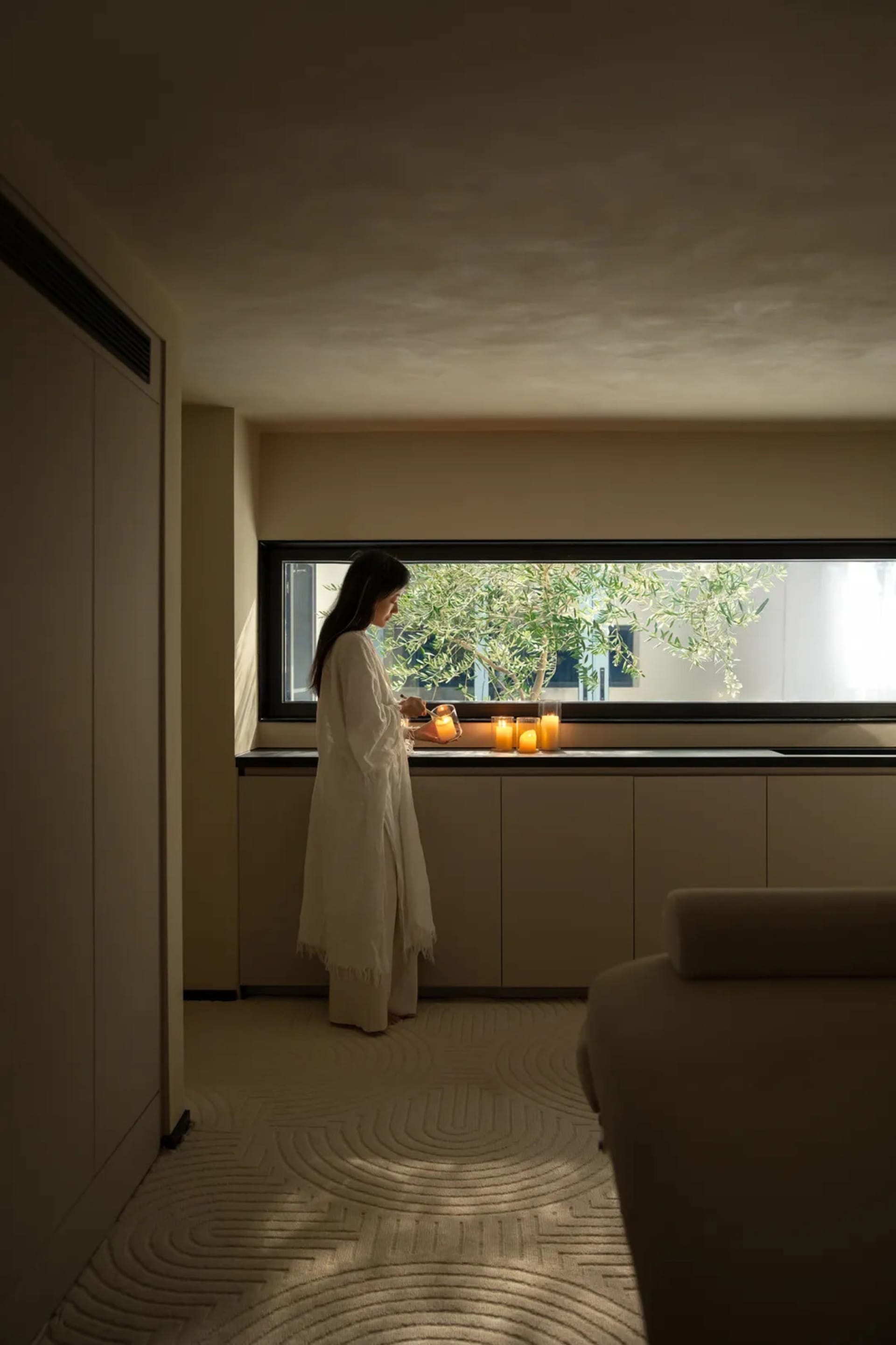 A modern residential interior with textured cloth flooring and minimalistic decor.