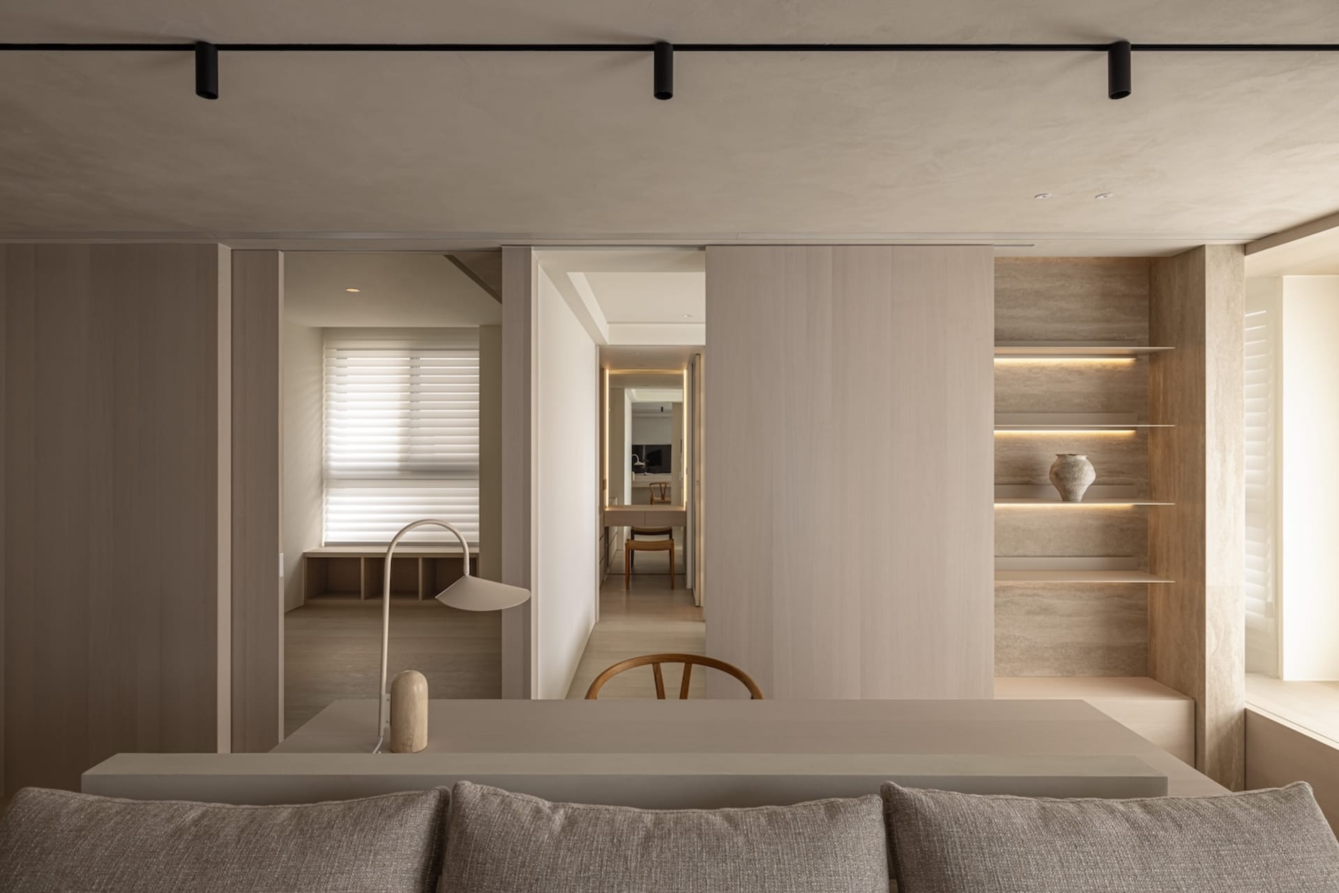 A modern minimalist living room featuring wooden elements and a neutral color palette.