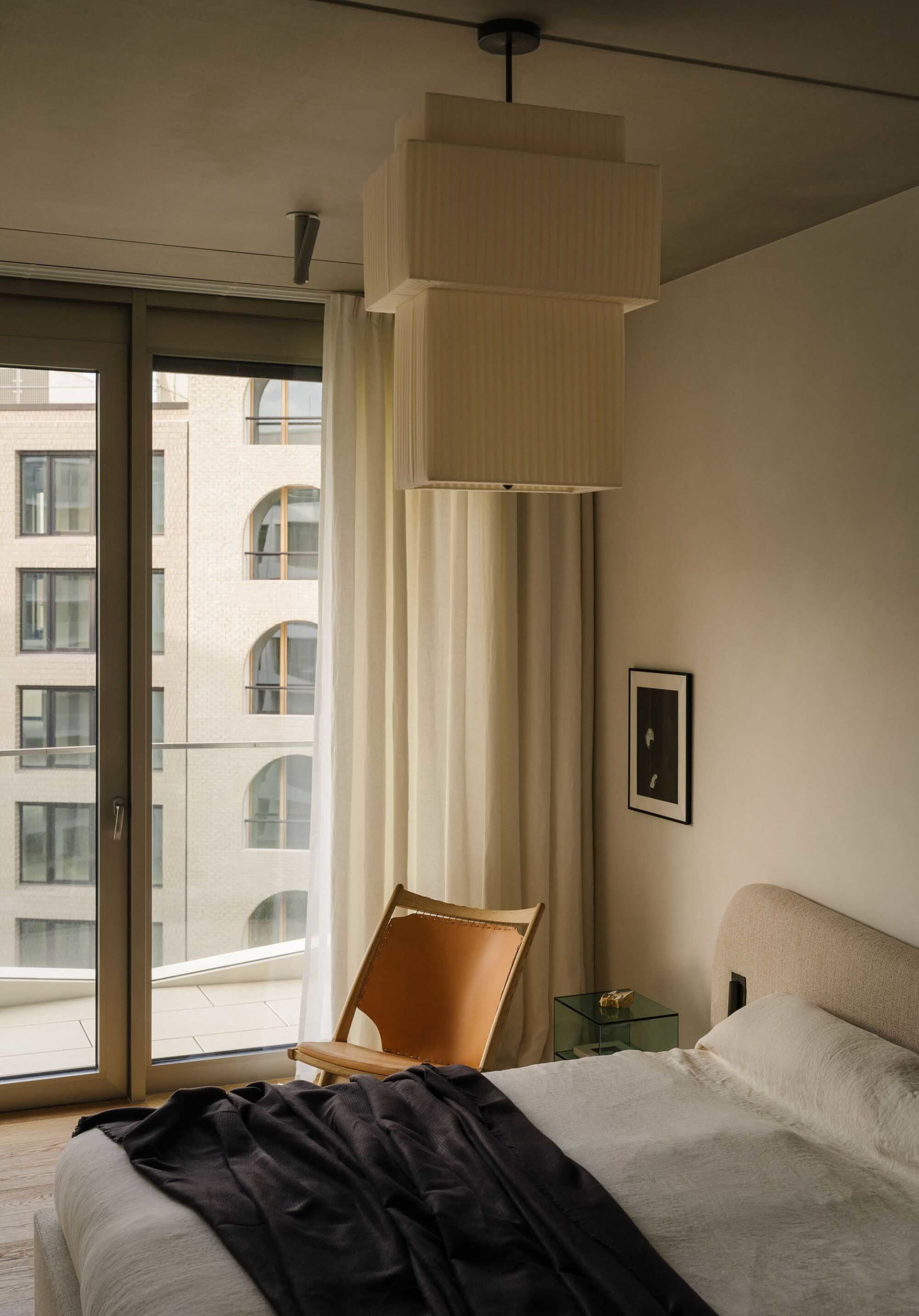 Minimalist bedroom with neutral tones and minimalist decor.