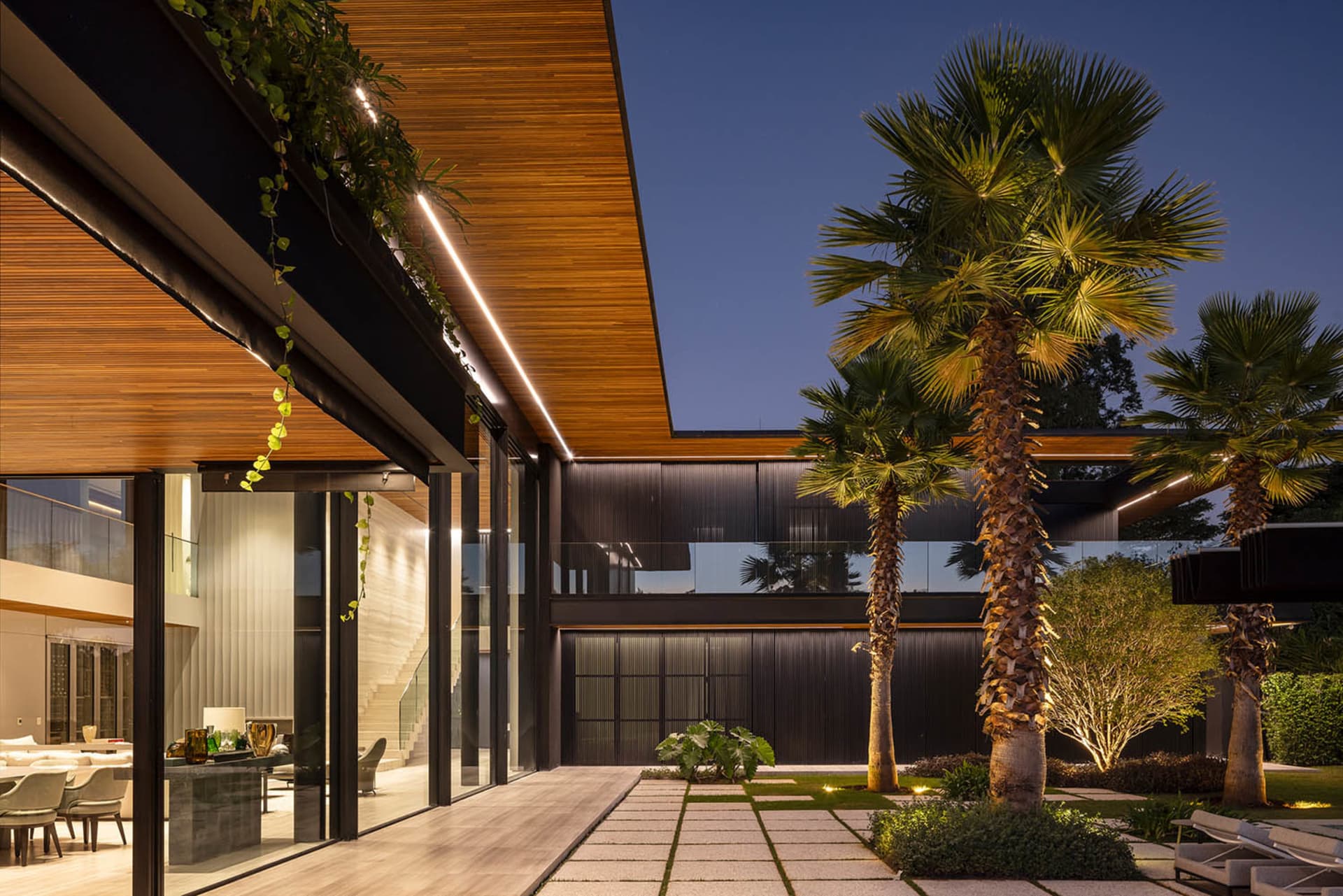 Modern residential exterior featuring wooden and glass elements.