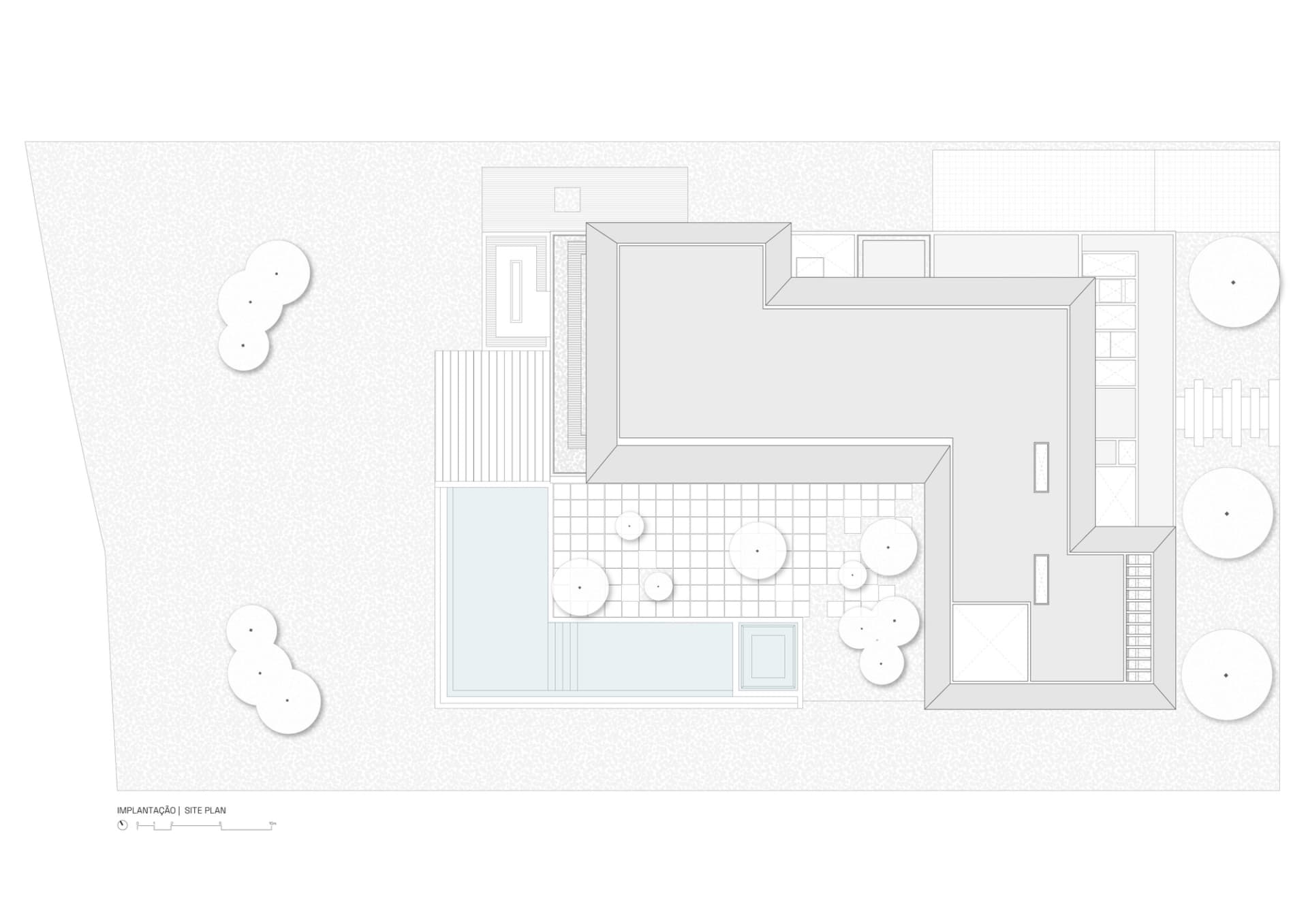 Top-down view of a site plan with buildings, pathways, and areas marked.