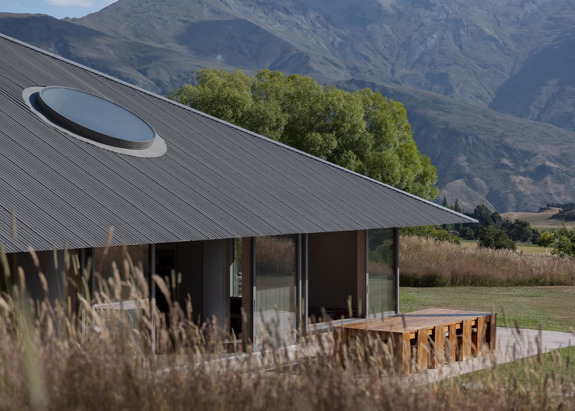 A modern residential building featuring a roof with metal roofing material.