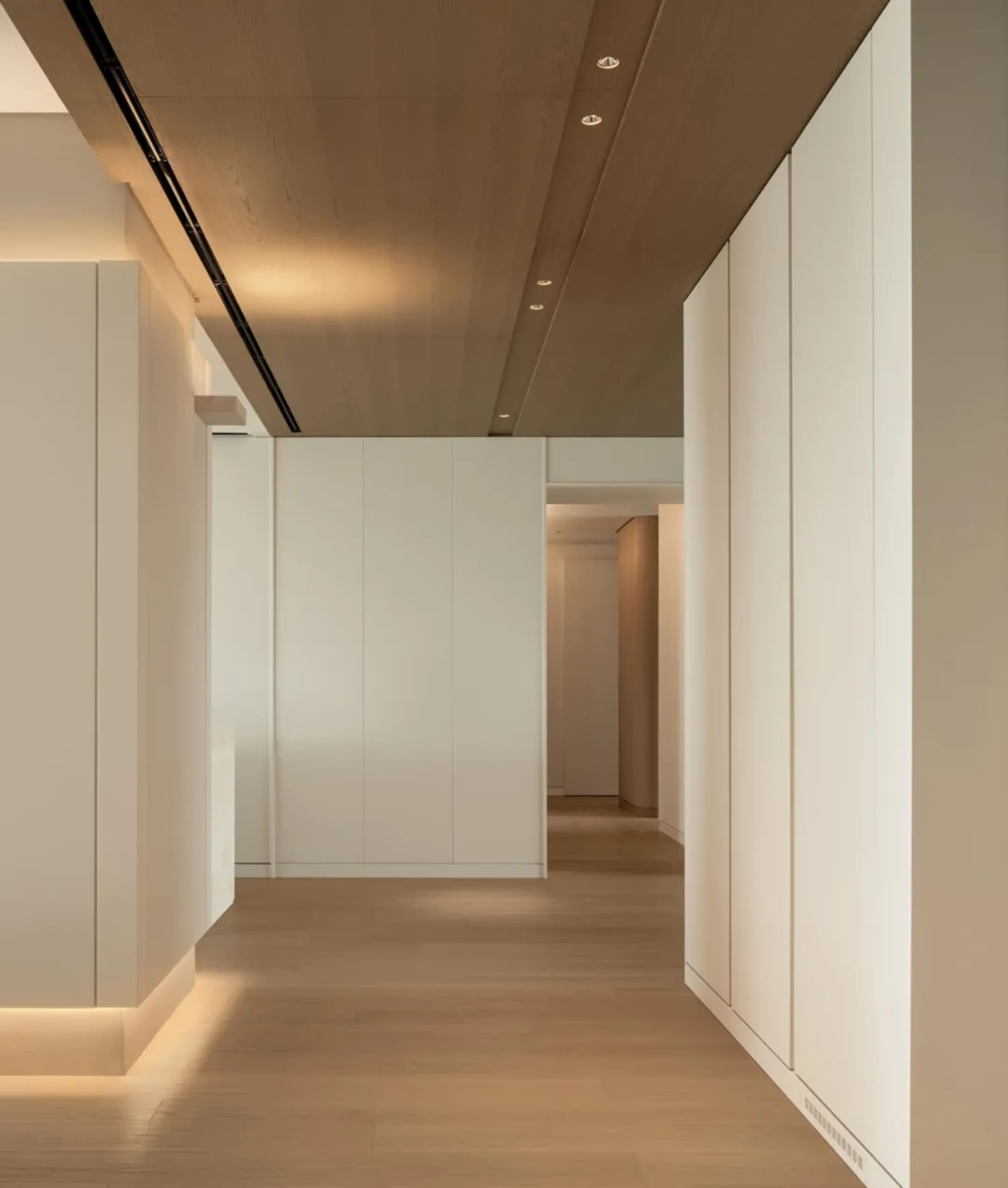 Modern minimalist interior design featuring white wood and sleek white walls.