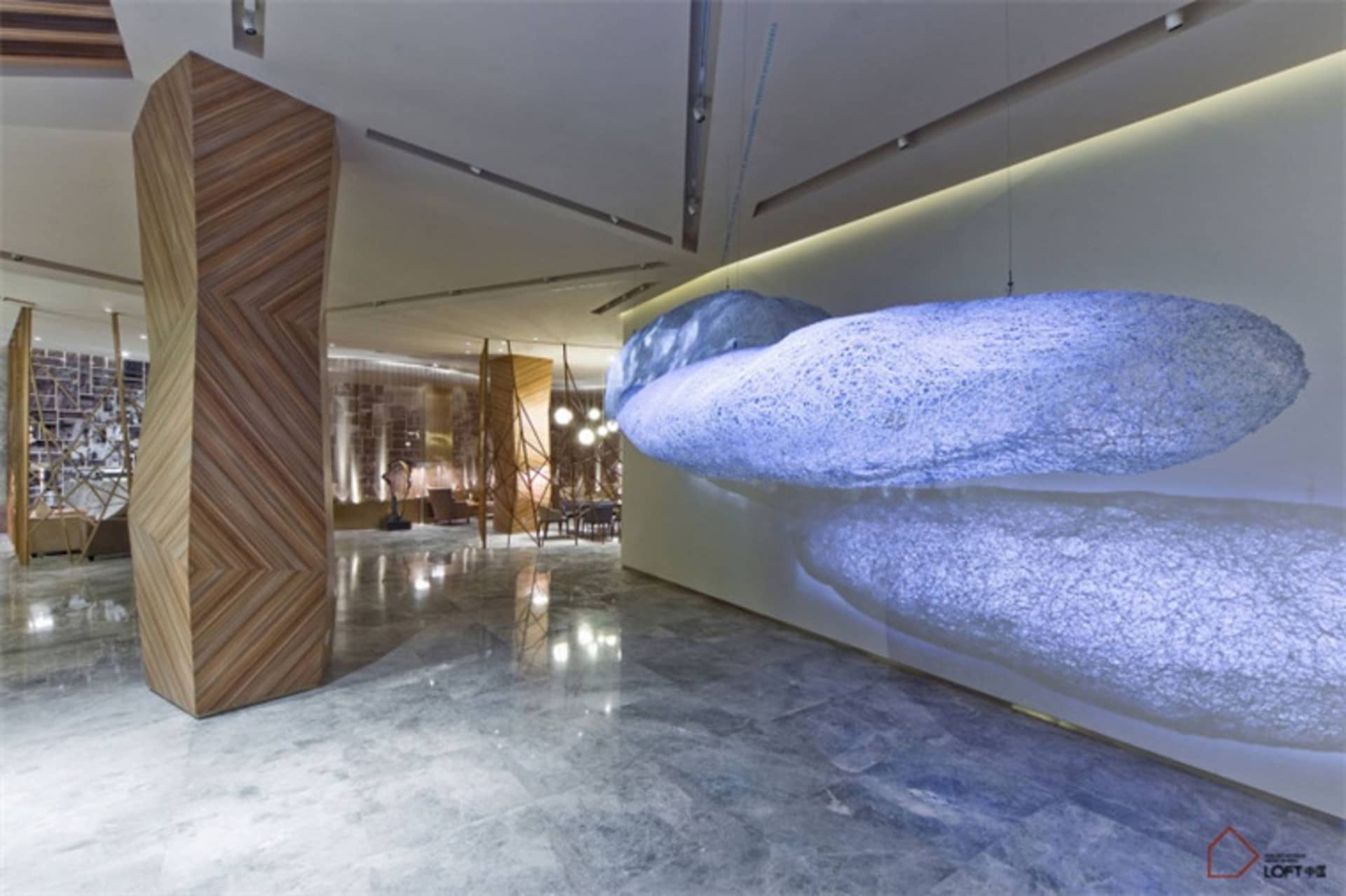 A modern commercial space featuring marble, glass, and concrete materials