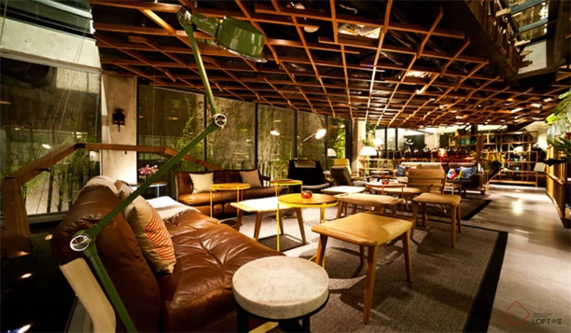 A modern loft interior with cushions and leather furniture.