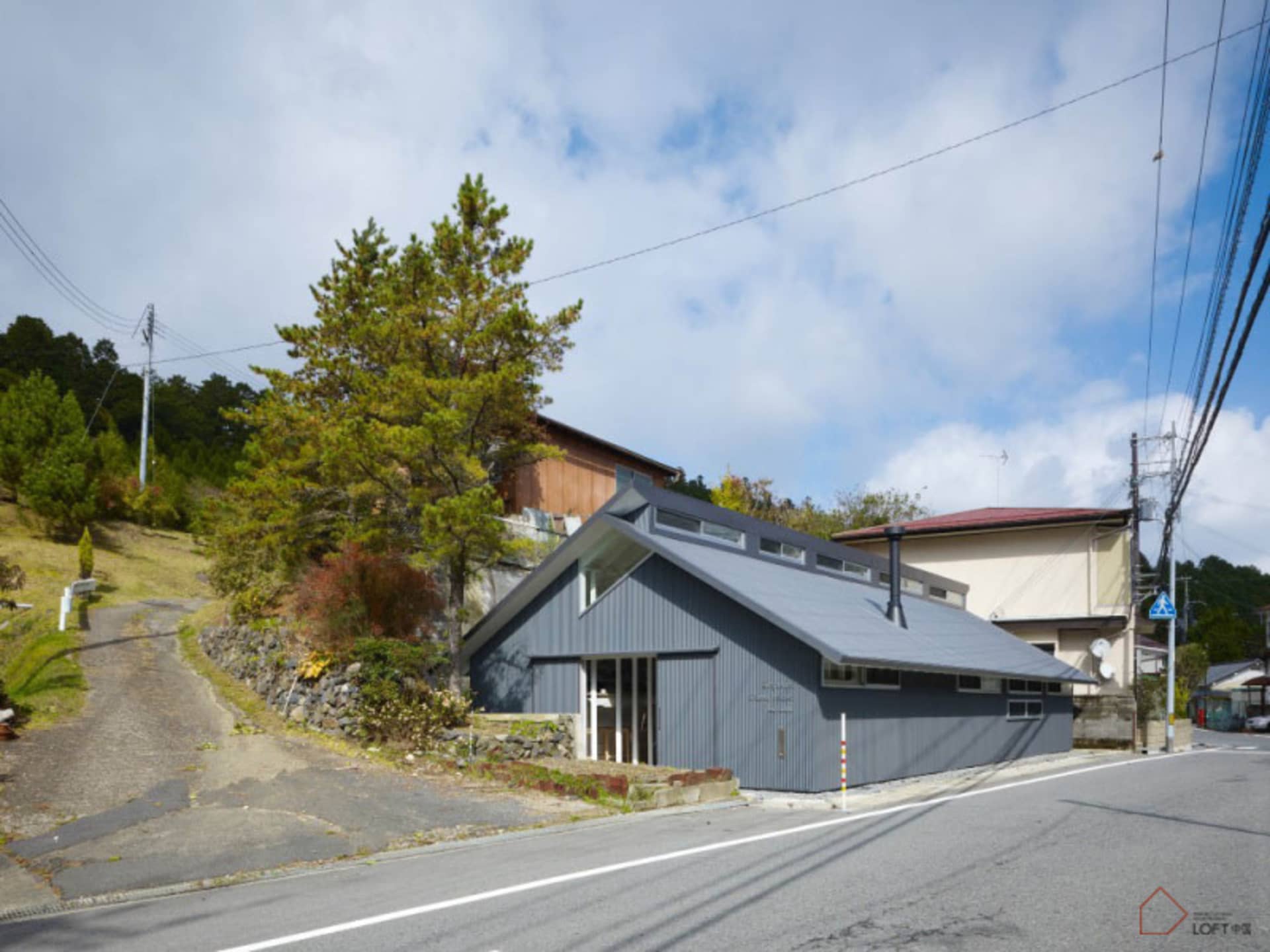 A modern residential building with metal siding and a unique architectural design.