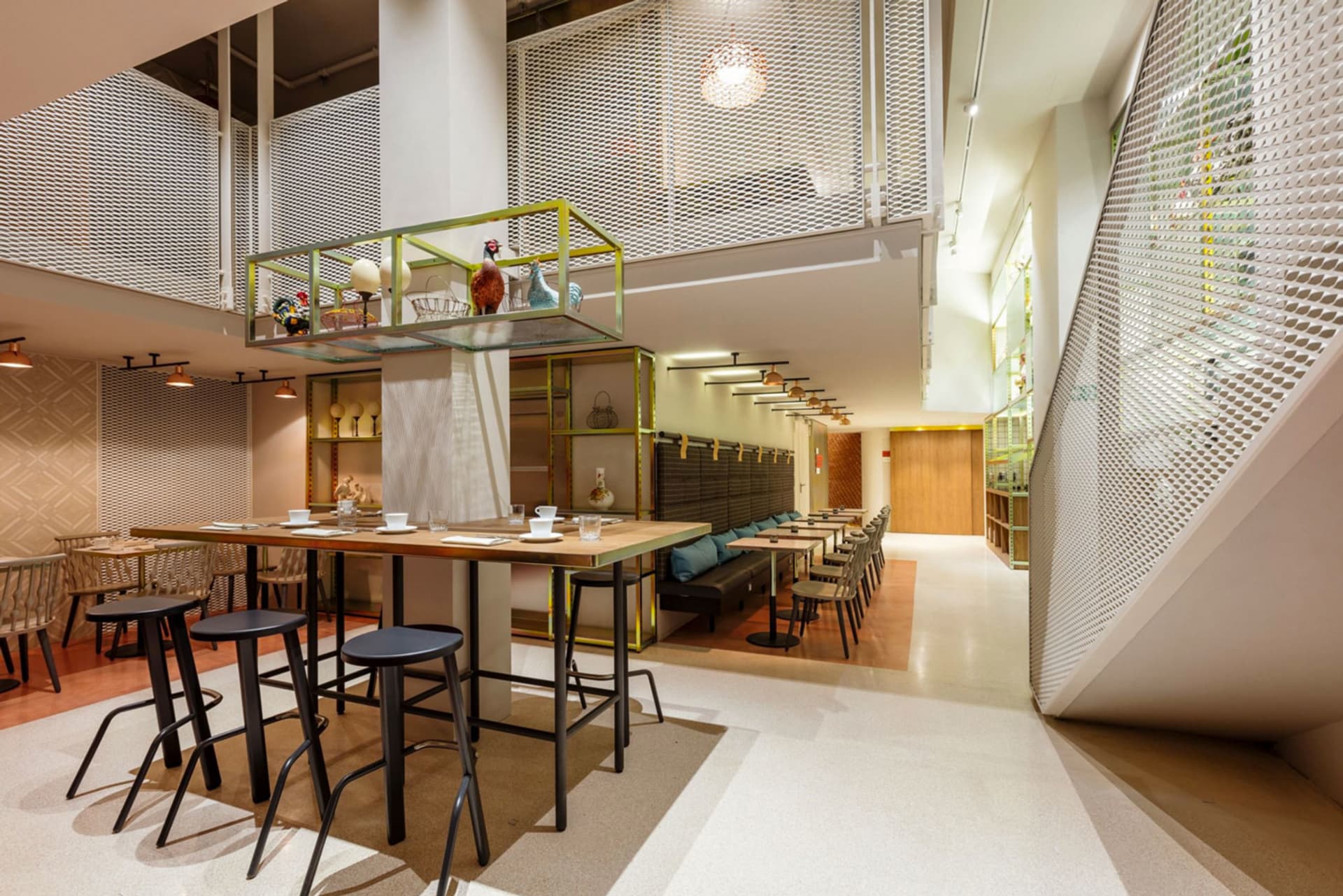 A modern cafe interior with metal, wood, and glass materials.