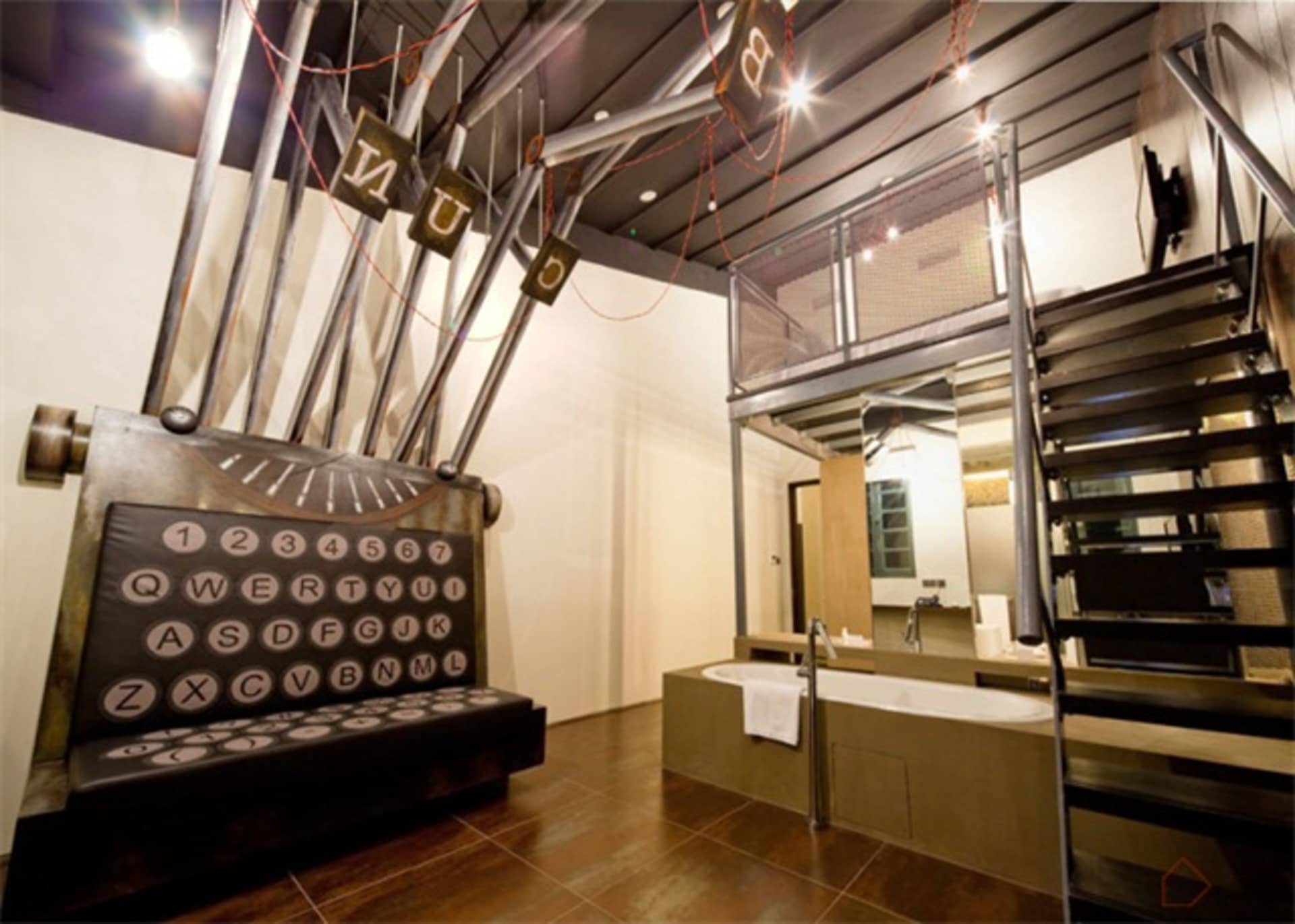 A hotel suite with an industrial design featuring metal and glass elements.