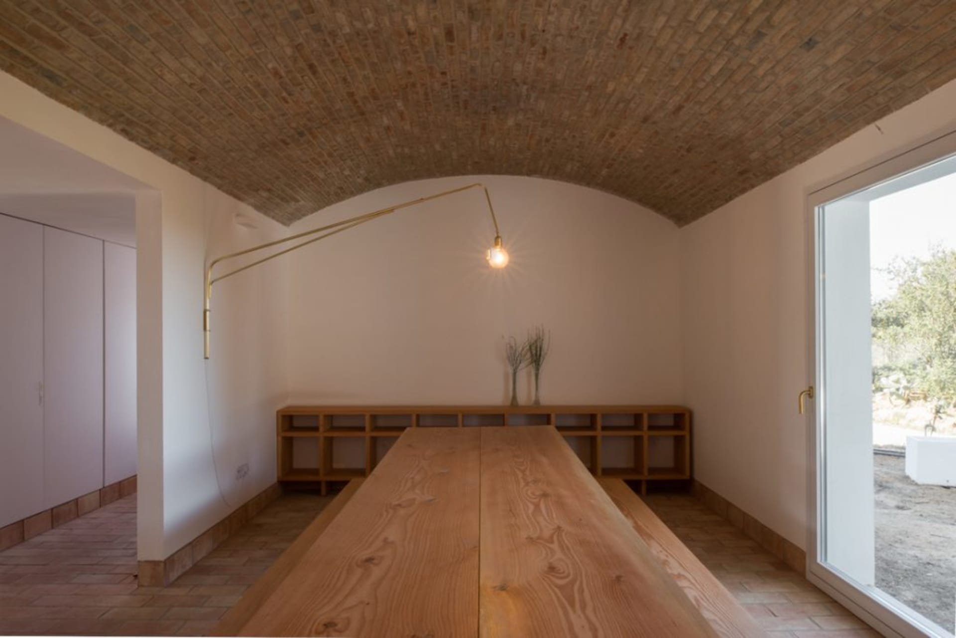 Minimalist kitchen featuring wooden countertops and brick ceiling