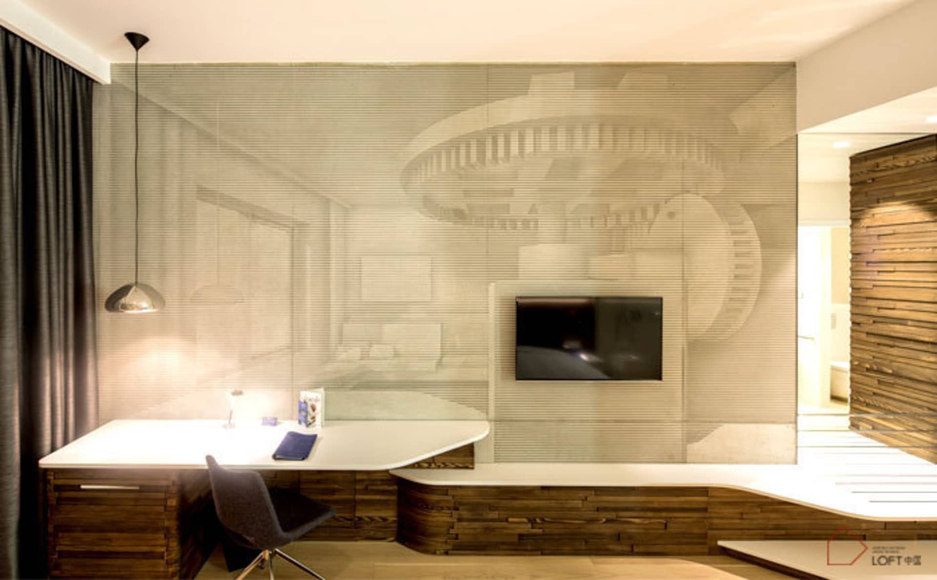 A modern office space featuring a tiled backdrop and a sleek, white desk with a pendant light hanging above it.