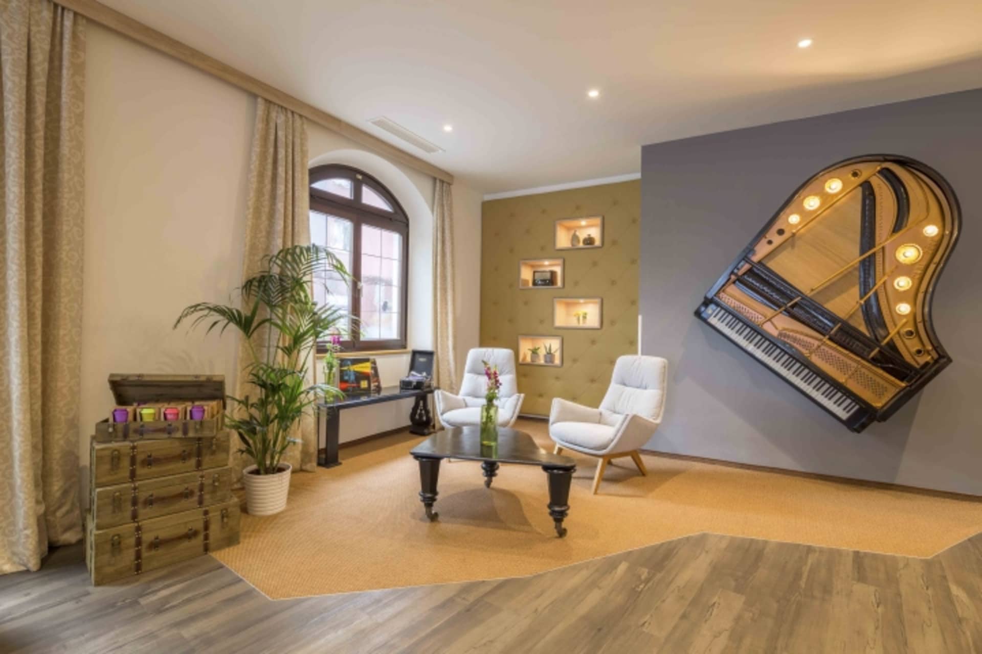 A living room with industrial design elements, featuring wooden furniture, fabric seating, and metal accents.
