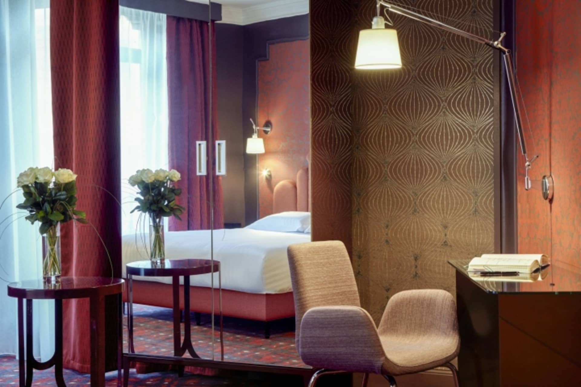 Modern hotel room featuring a textured paper wall and contemporary furniture.
