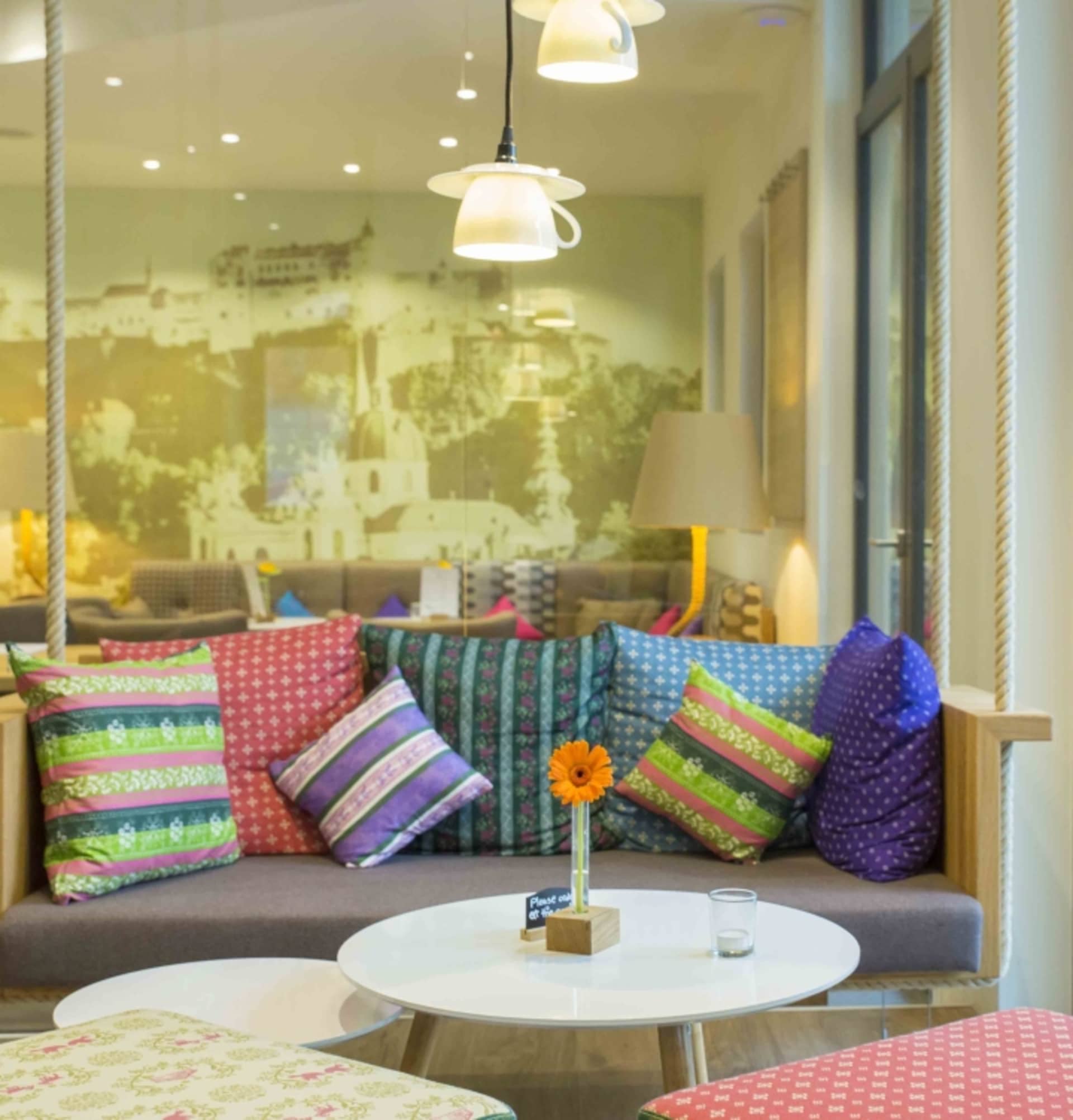 A cozy lounge area with a variety of colorful, patterned throw pillows on a comfortable sofa.