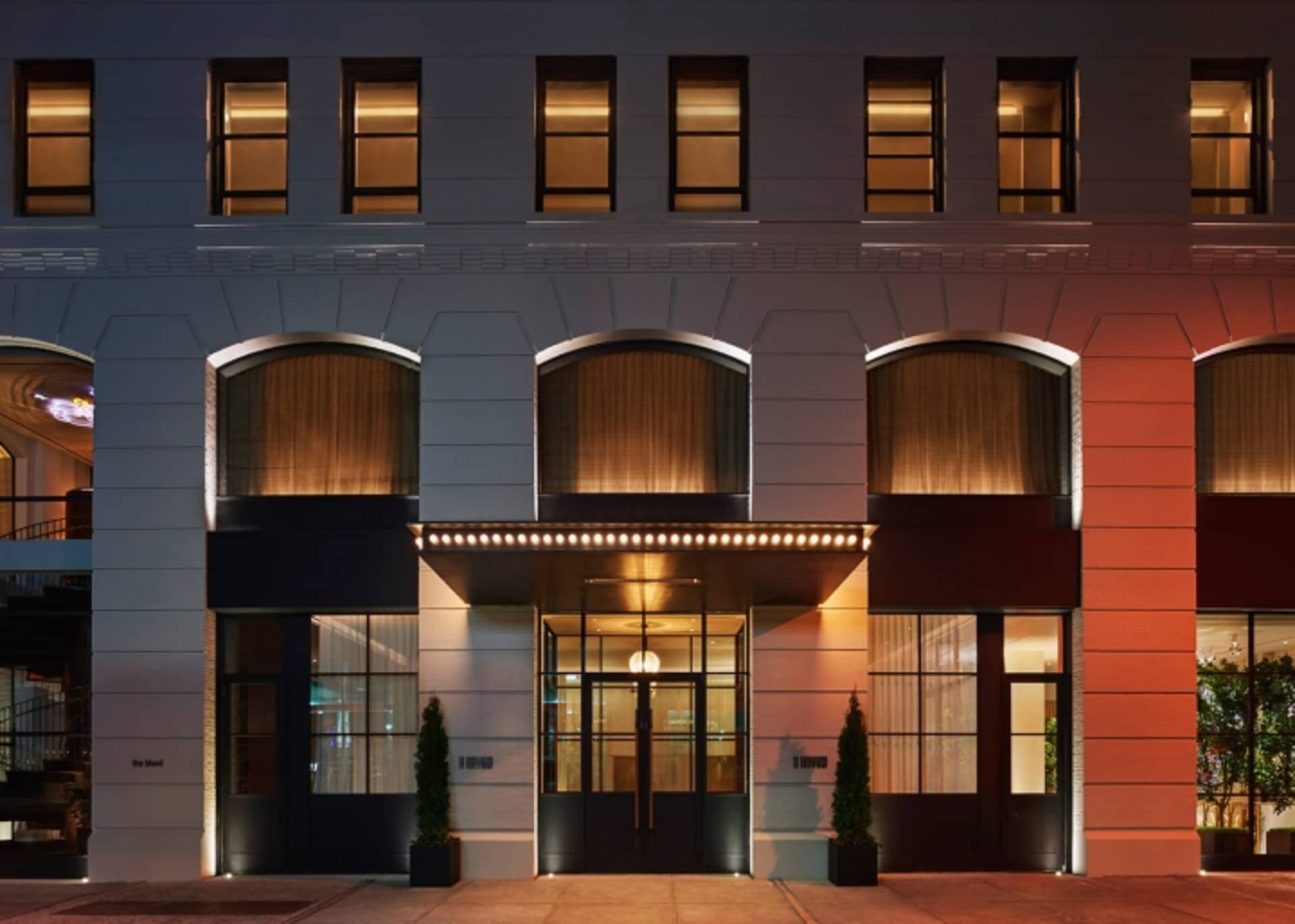 Modern hotel entrance featuring brick and concrete materials.