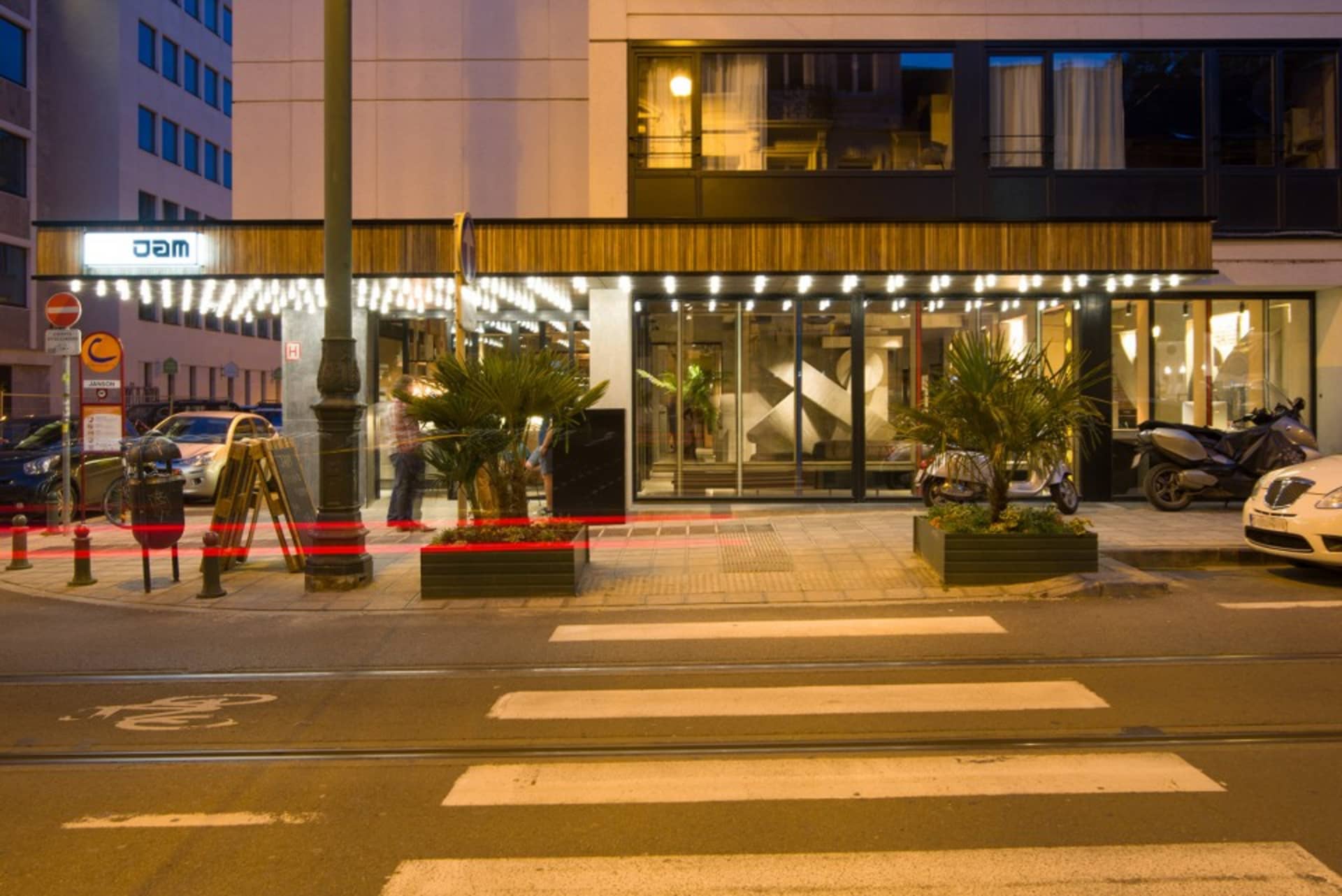 Modern hotel entrance with concrete and glass materials.
