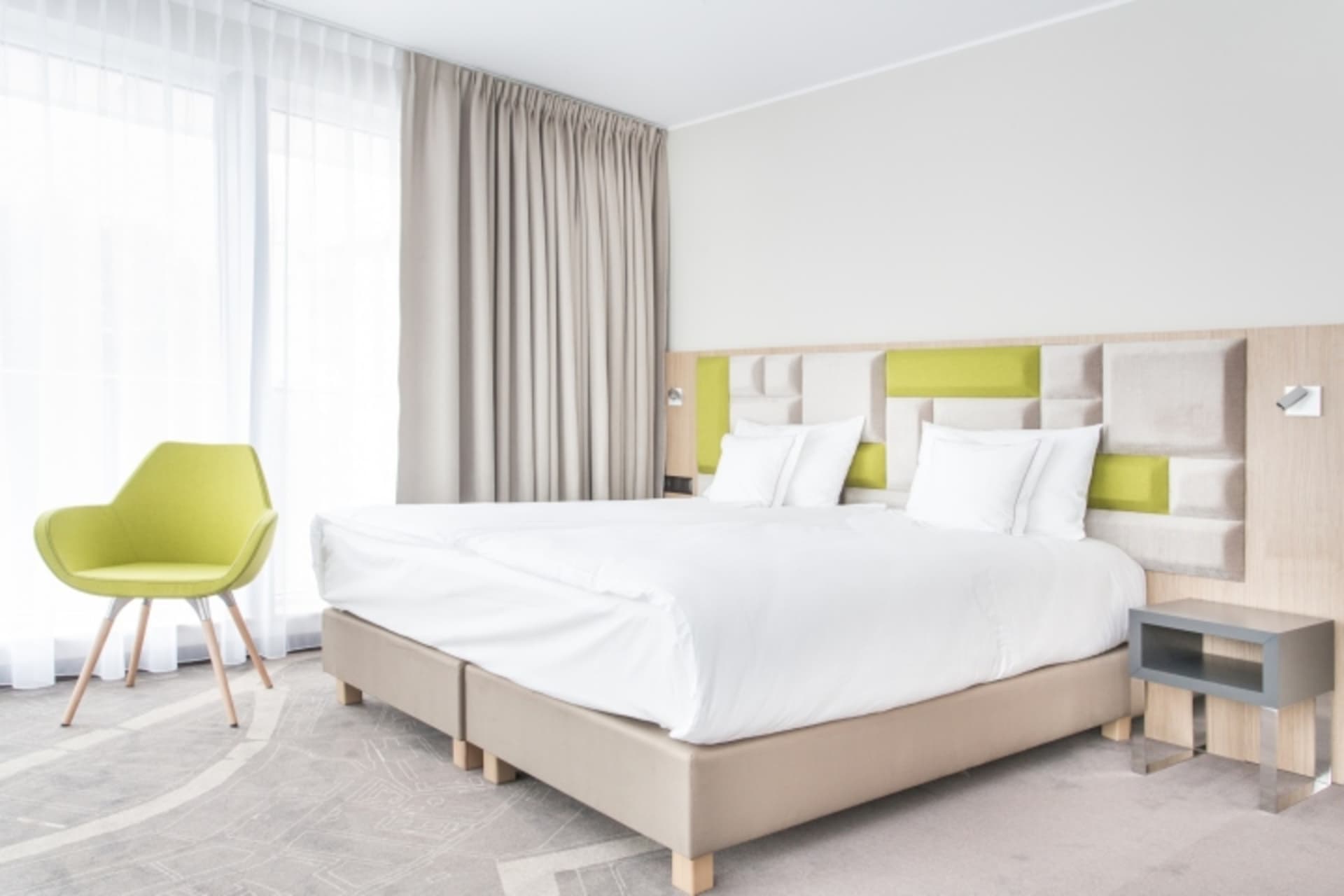 Modern minimalist bedroom with a soft, neutral textile color palette.