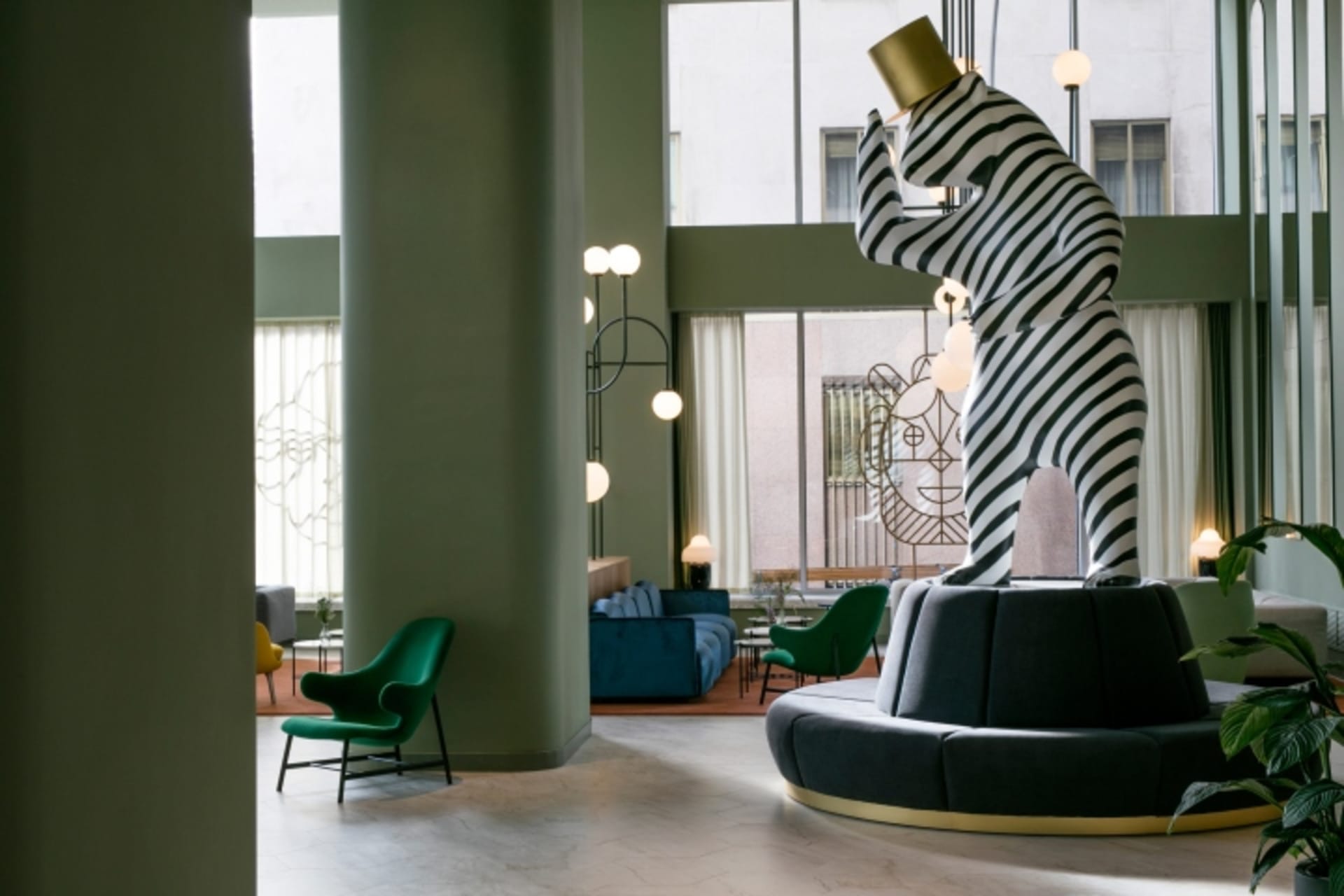 A modern lobby featuring a striking black and white striped tower sculpture.