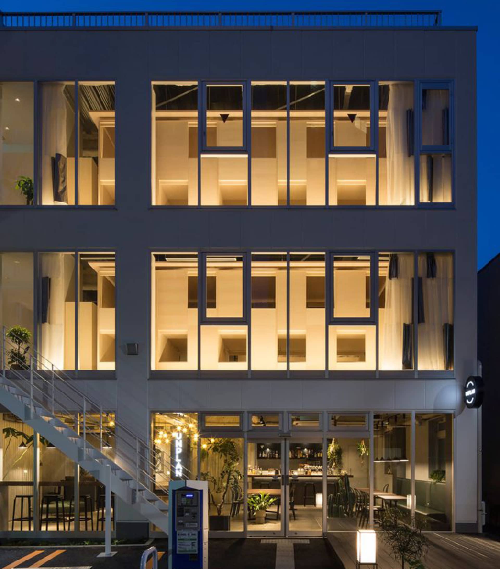 Modern restaurant-bar interior with large glass windows and tiled flooring