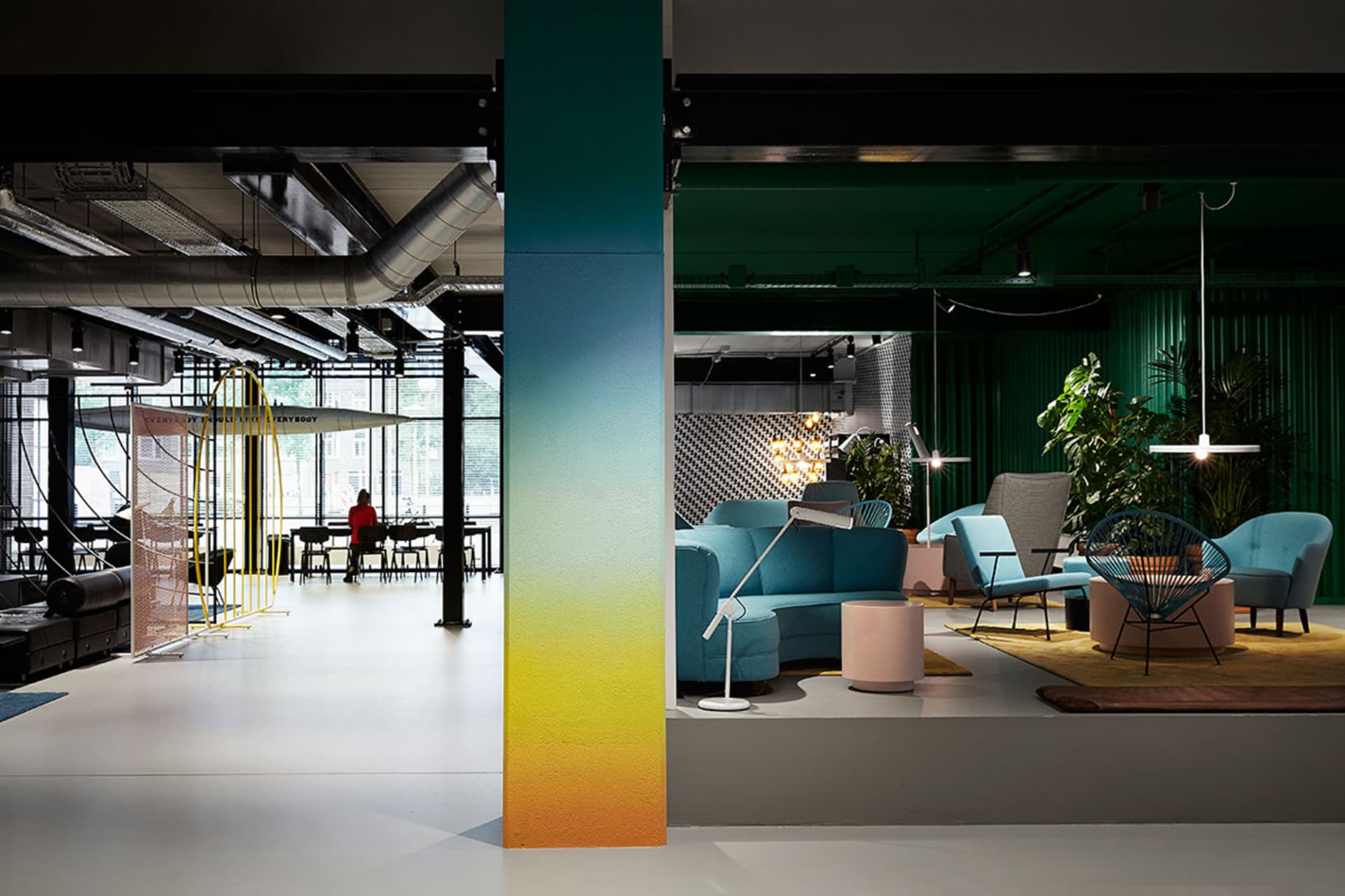 Modern lobby with white floors, blue furniture, and concrete accents.