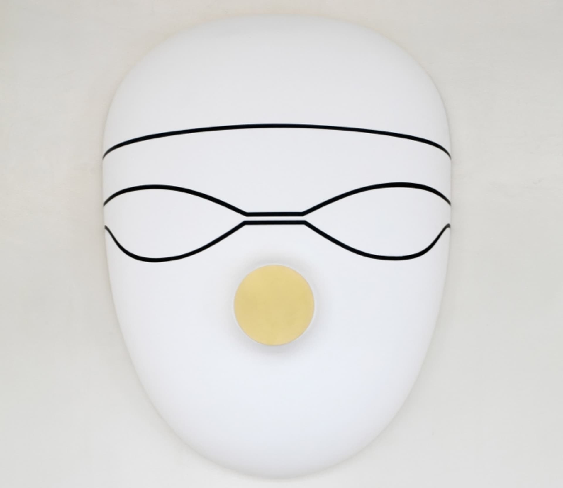 A white, metal mask with a yellow circular element